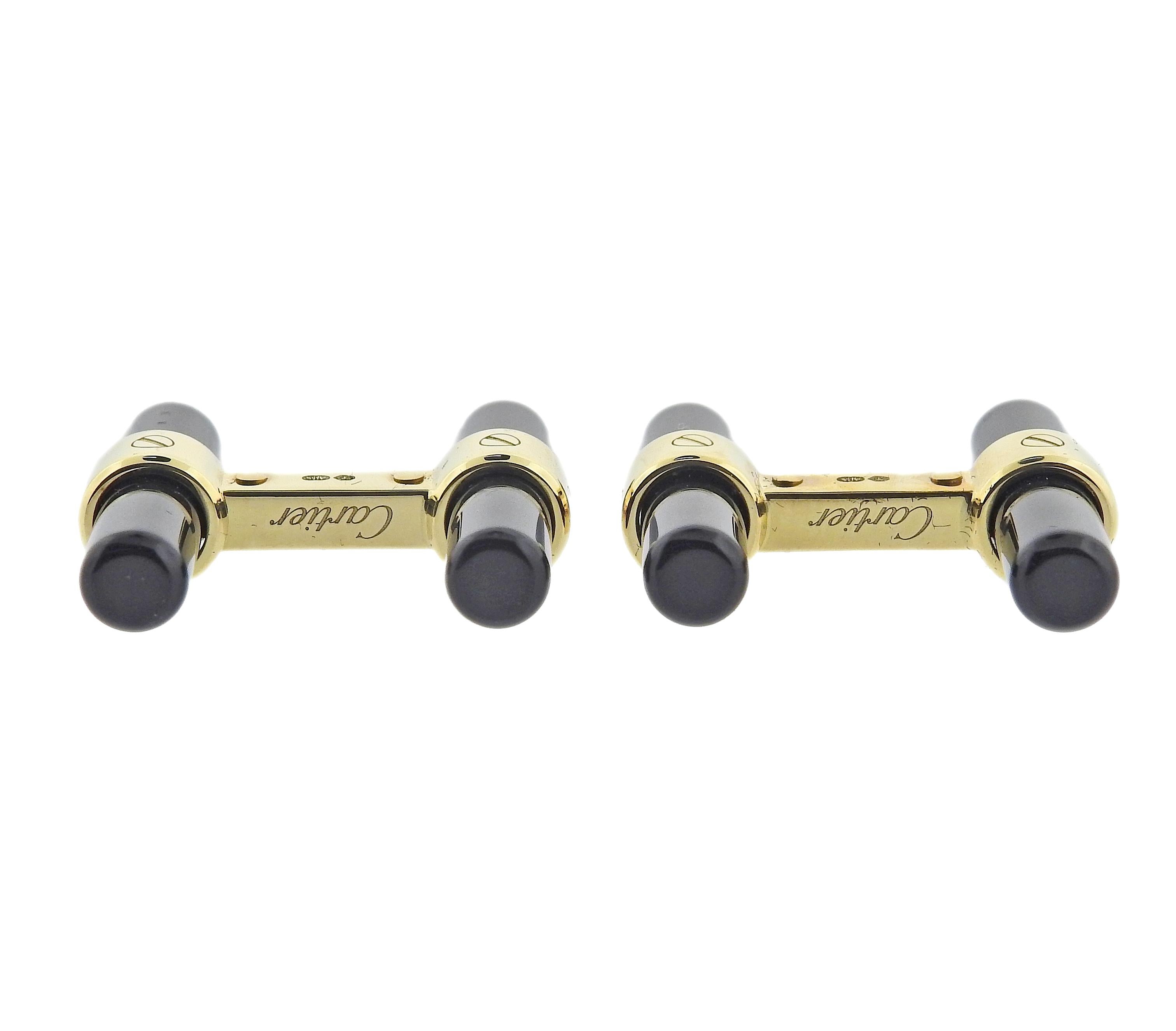 Pair of Cartier interchangeable bar cufflinks in 18K yellow gold with onyx, lapis, rhodochrosite, jade. Cufflinks measure 23mm x 5mm. Marked: Cartier, made in France, A5073, Au750. Weight is 11.5 grams.