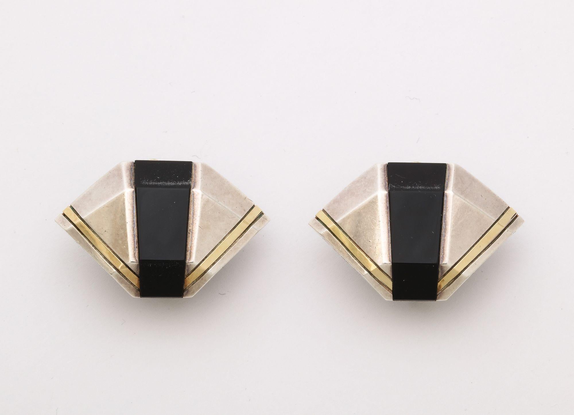 A wonderful pair of Cartier signed Geometric Sterling and 18 k Gold Clip Earrings. They measure 1 1/4 inch in length and 7/8 inch wide. Having a post back, the earrings are in good condition.