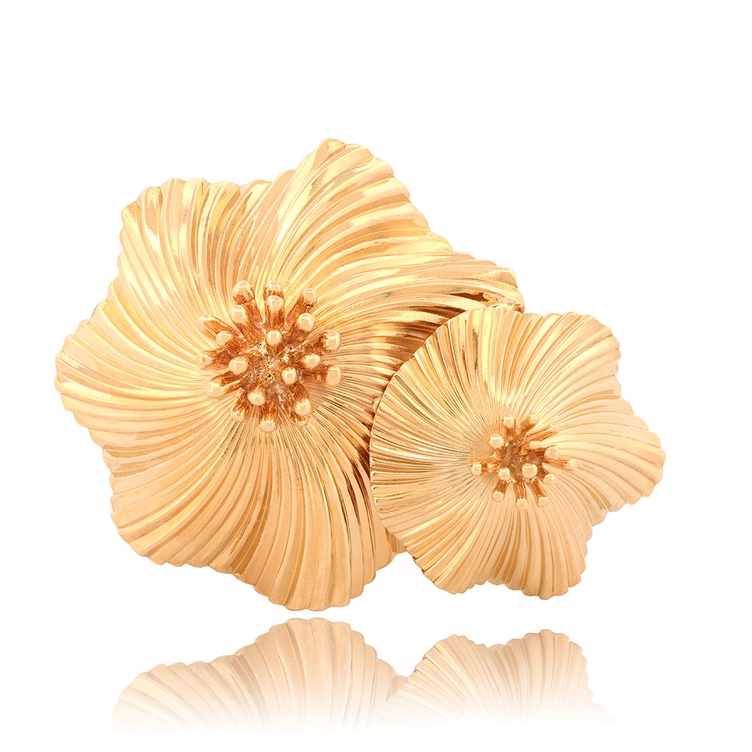 From Cartier designer George Schuler, this circa 1950’s 14 karat yellow gold flower brooch has a ridged texture with undulating petals and raised centers. The brooch has a polished finish and is stamped Cartier at the base of the pin hinge.
- 14k