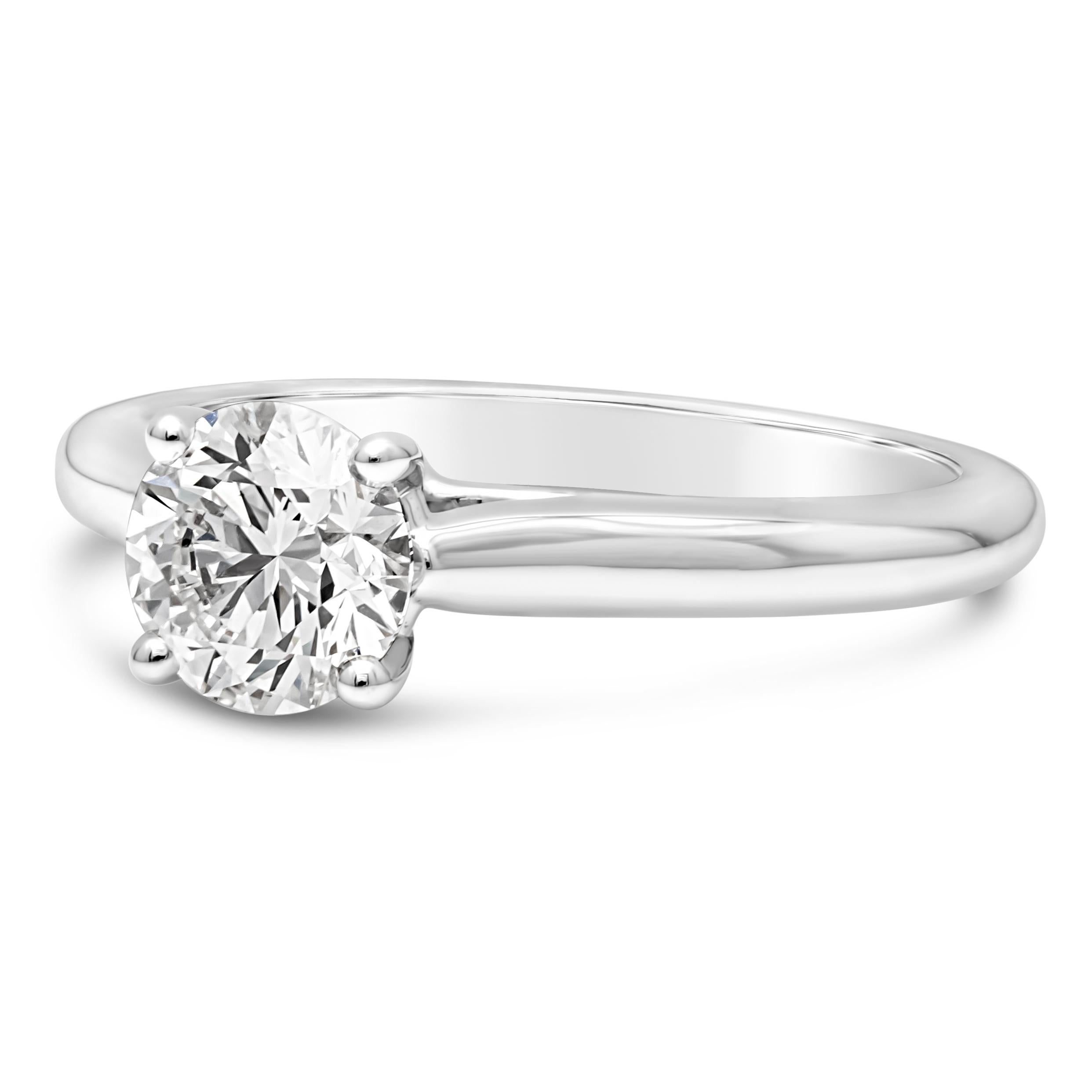 A classic and timeless engagement ring style, showcasing a 0.90 carat round brilliant cut diamond certified by GIA as G color and VVS1 clarity, set on a traditional solitaire four prong basket setting. Finely made with a platinum band. Size 5.75 US,