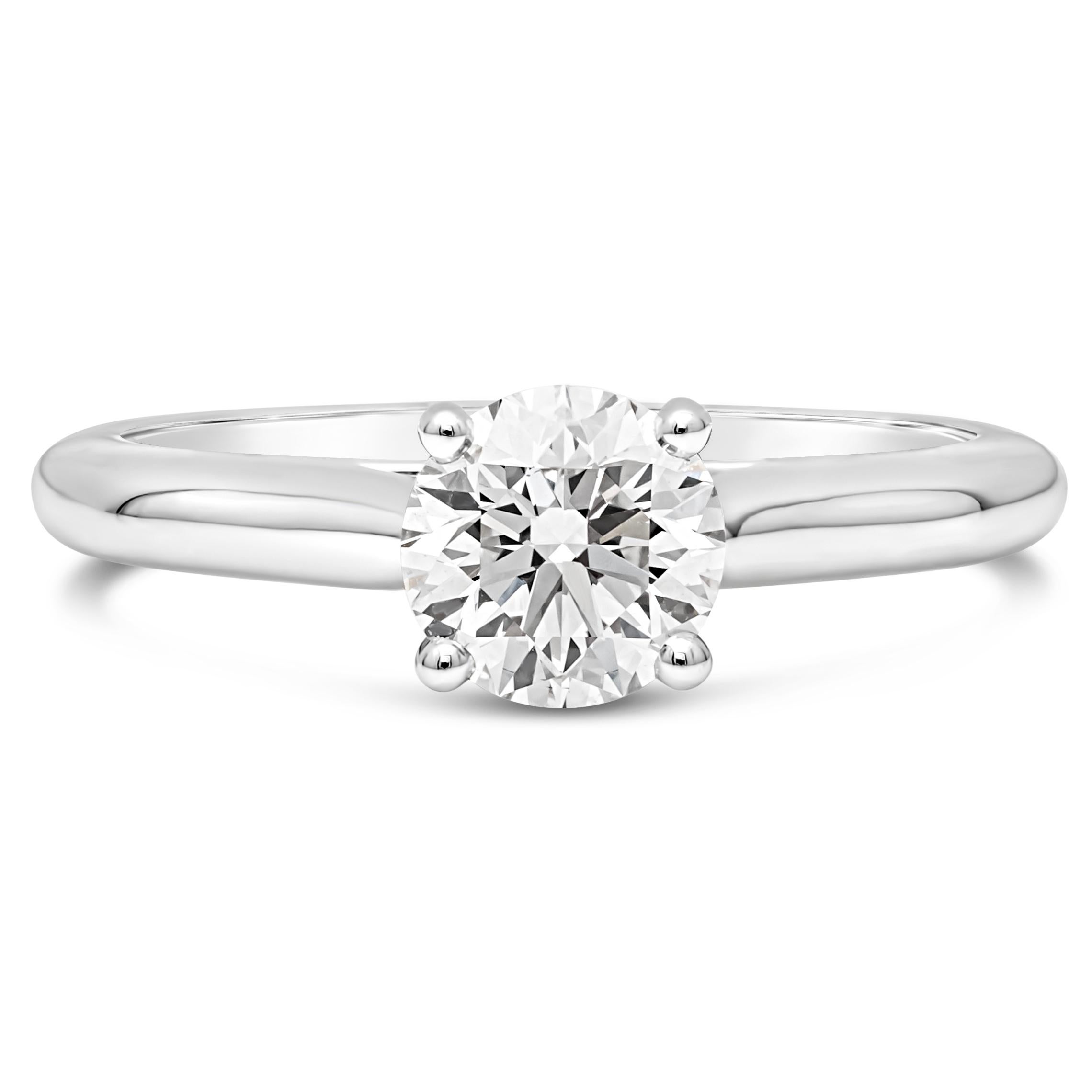 A classic and timeless engagement ring style made and Signed by Cartier at 1895 showcasing a 0.90 carats round brilliant diamond, set in a traditional solitaire four prong basket setting. Accompanied with a GIA report certifying the center diamond