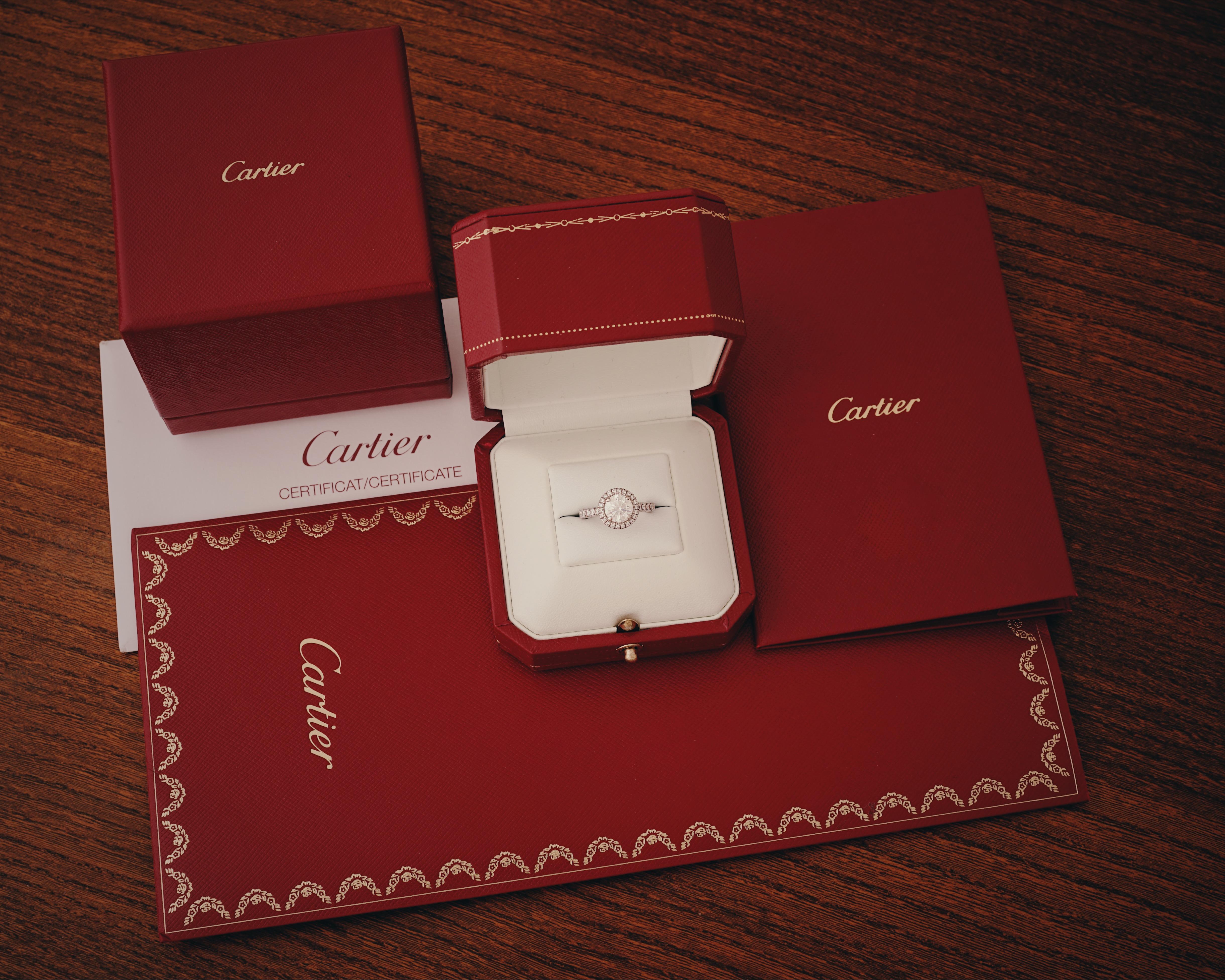 Cartier, Desitnée Solitaire,
Round Brilliant Cut
GIA certified 1.25 Carat, F Color and VVS1 Clarity and Triple X quality.
Mounted in Platinum 950/1000 and set with a halo of brilliant cut diamonds. 
Signed Cartier, and numbered. Size 48 (US 4.75),