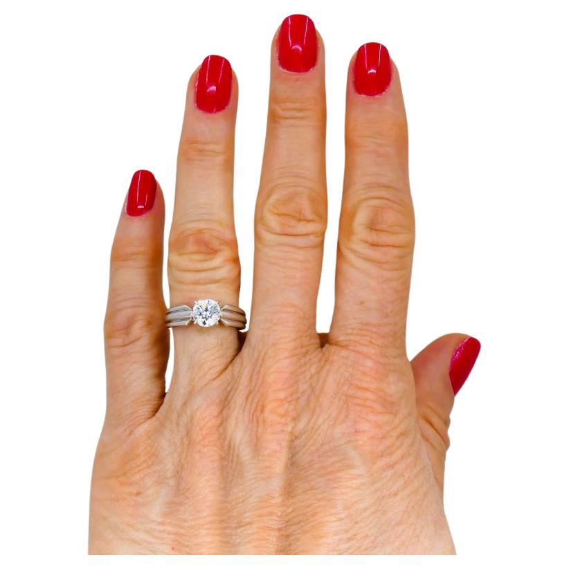 A Cartier platinum diamond solitaire ring with a GIA certificate and the original receipt dated March 2003.   
The diamond featured in this Cartier engagement ring has exceptional grades that meet Cartier’s highest quality standards. The gem is