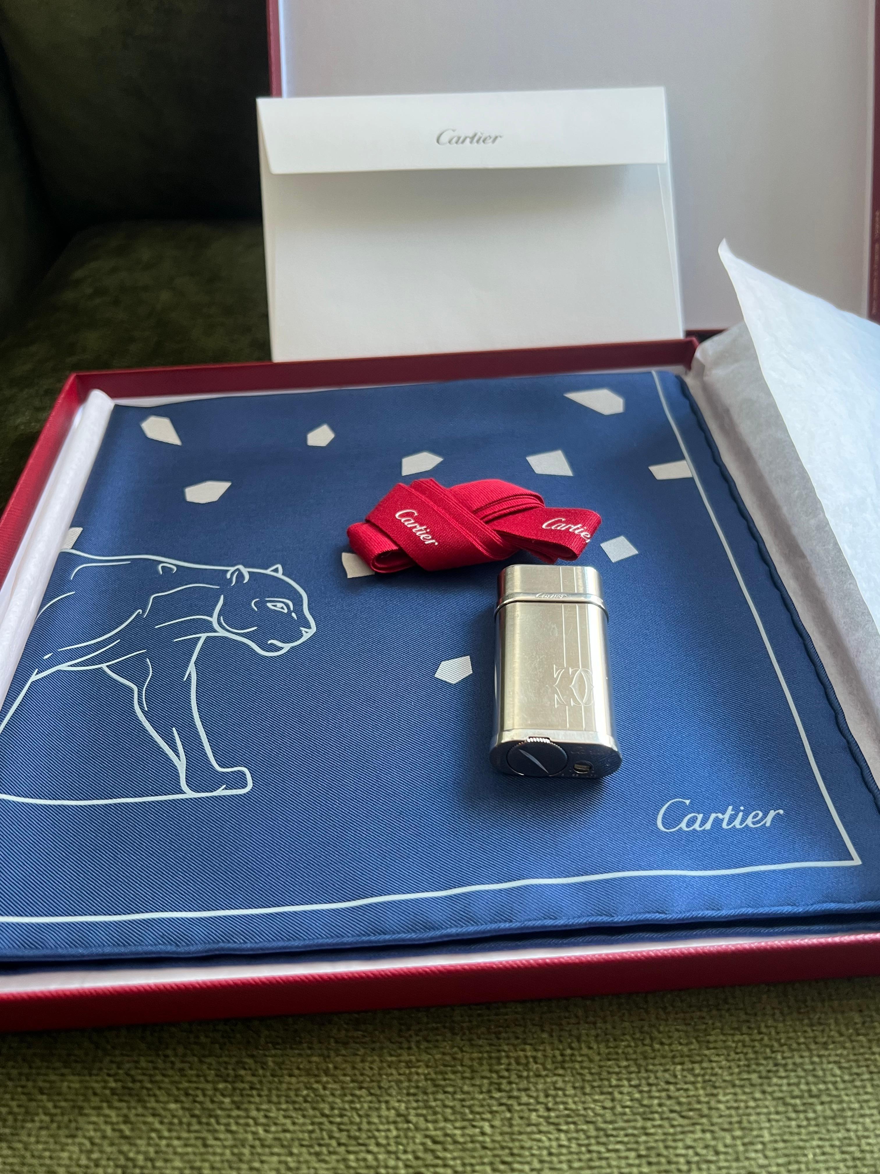 Cartier Gift Set, Palladium Lighter & Cartier Silk Scarf Original Cartier Case
Set of 2

1 - Rare Cartier Lighter Palladium Finish Logo front 
Circa 2000

2 - Authentic Cartier Silk Scarf Blue Panthere Panther with Original VIP Cartier Case 
100