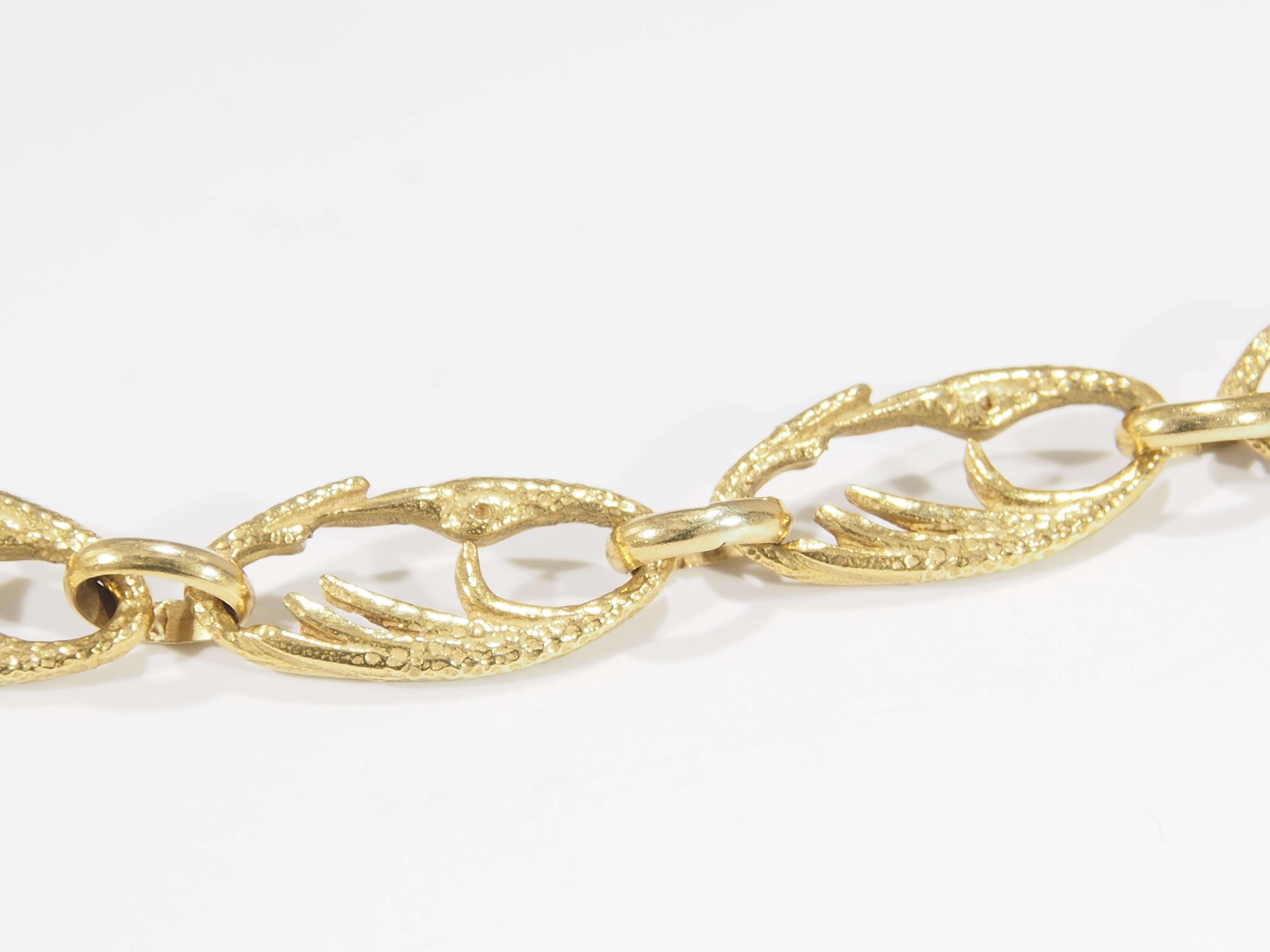 This is a stunning Vintage Cartier Link Necklace handcrafted in 18K Yellow Gold. The Necklace design consists of stylized links in the shape of joined Swans that are 1/4 of an inch in width, for a total of 30 inches in length. There are hallmarks of
