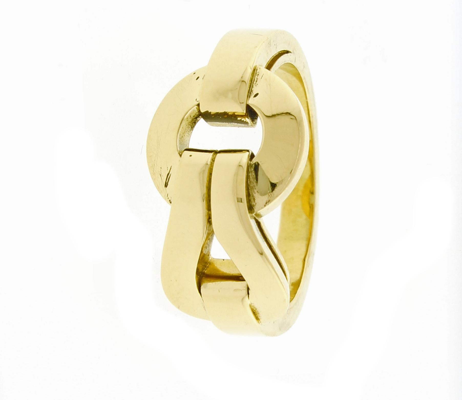 Cartier 18 karat yellow gold  Agrafe ring. Cartier borrowed the central motif for this jewelry collection from the world of fashion. Inspired by the clasps of the corsets this 18 karat yellow gold ring is refined and sophisticated.  Signed and