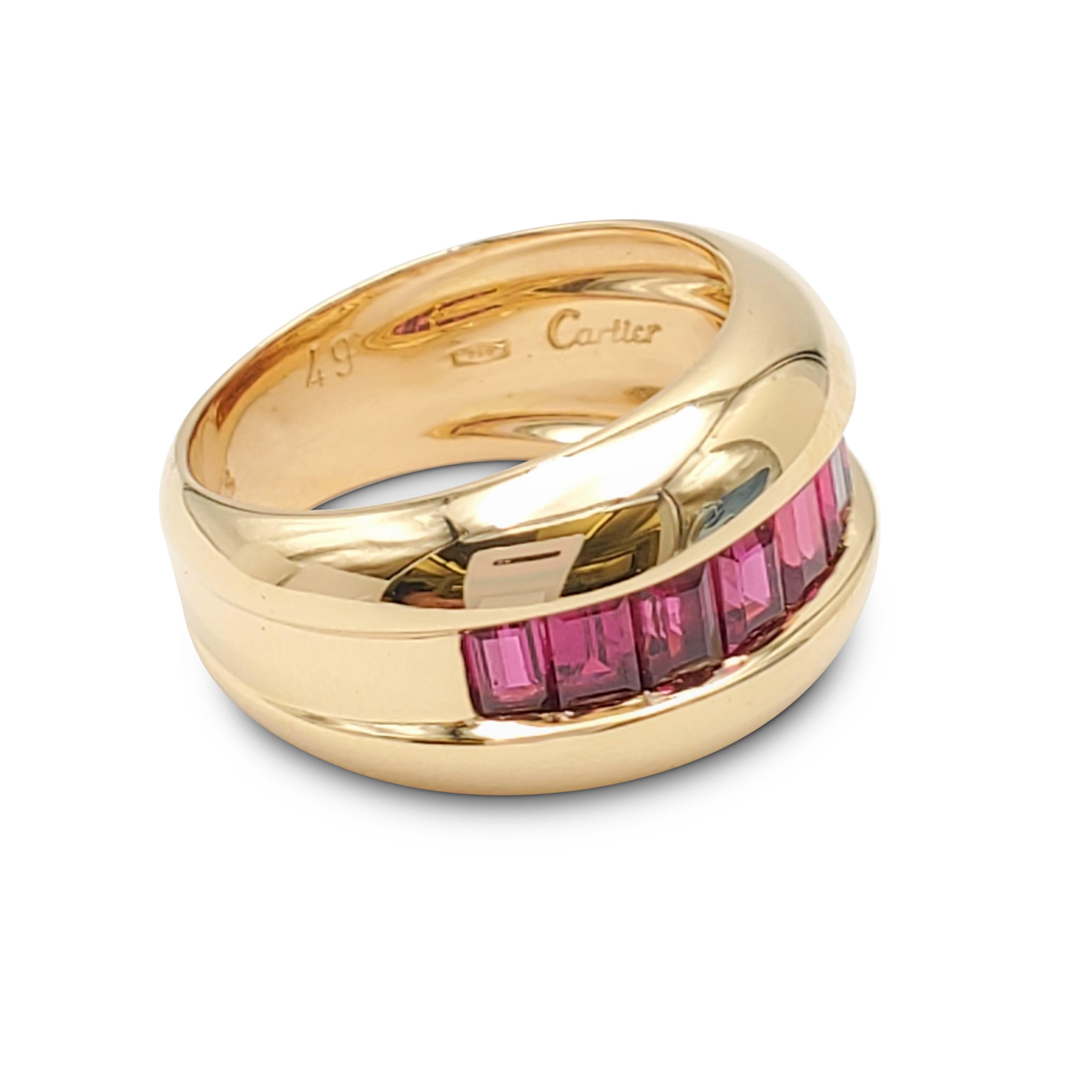 Authentic Cartier ring crafted in 18 karat yellow gold featuring calibre cut rubies weighing an 1.00 estimated carts in total weight. Signed Cartier, 750, 49, with serial number and hallmarks. Ring size 4 3/4. The ring is not presented with the