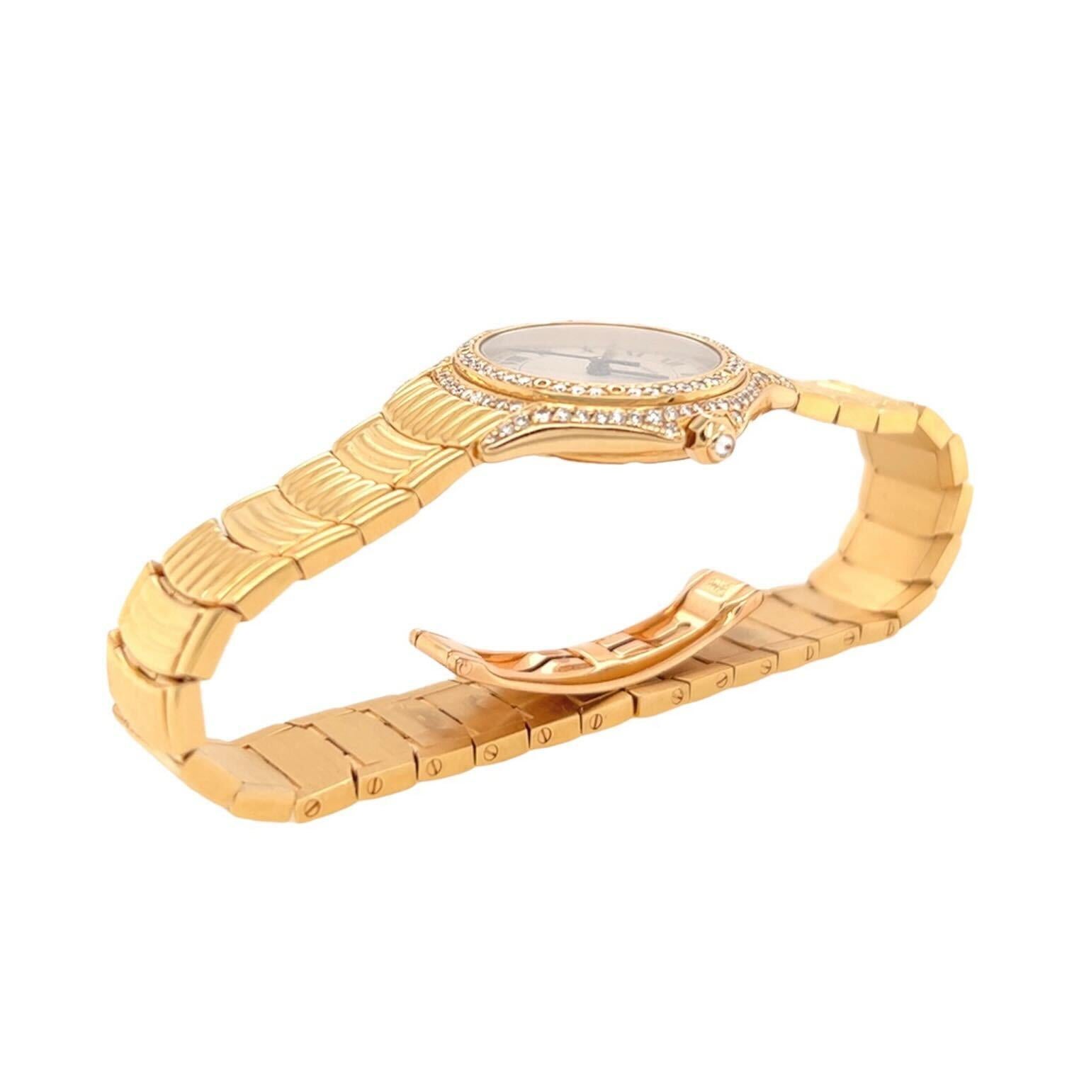 An 18 karat yellow gold and diamond watch, Cartier.  The quartz movement “Cougar” watch with a cream colored dial, Roman numerals, secret signature at 10, date window at 3, a bezel set with approximately one hundred ten diamonds in two rows and a