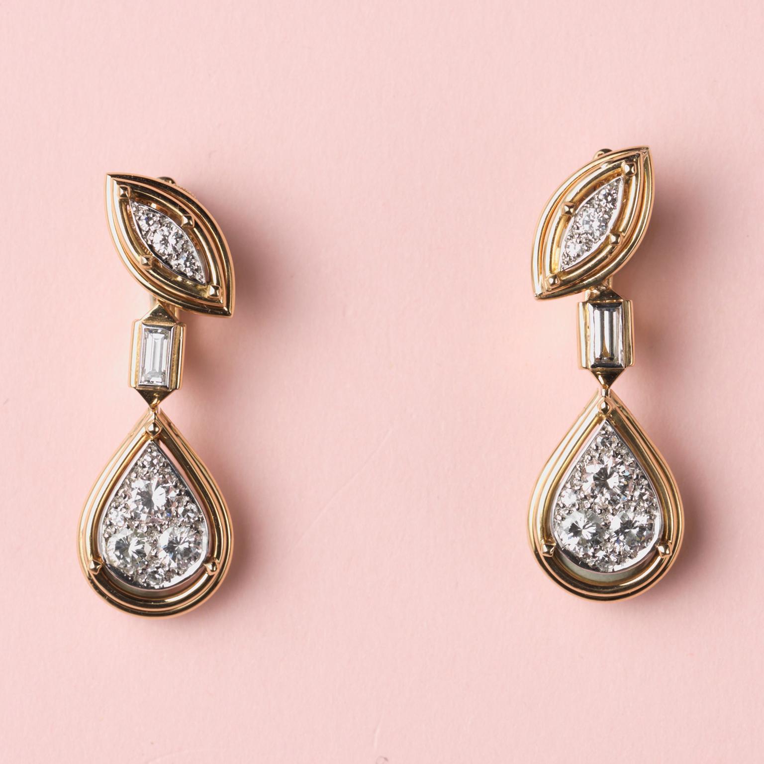 A pair of 18 carat gold and platinum earrings; with at the top a marquise shaped element of gold wire set with brilliant-cut diamonds, from which hangs – connected by a baguette-cut diamond – a pear-shaped drop with gold wire and diamonds, all set