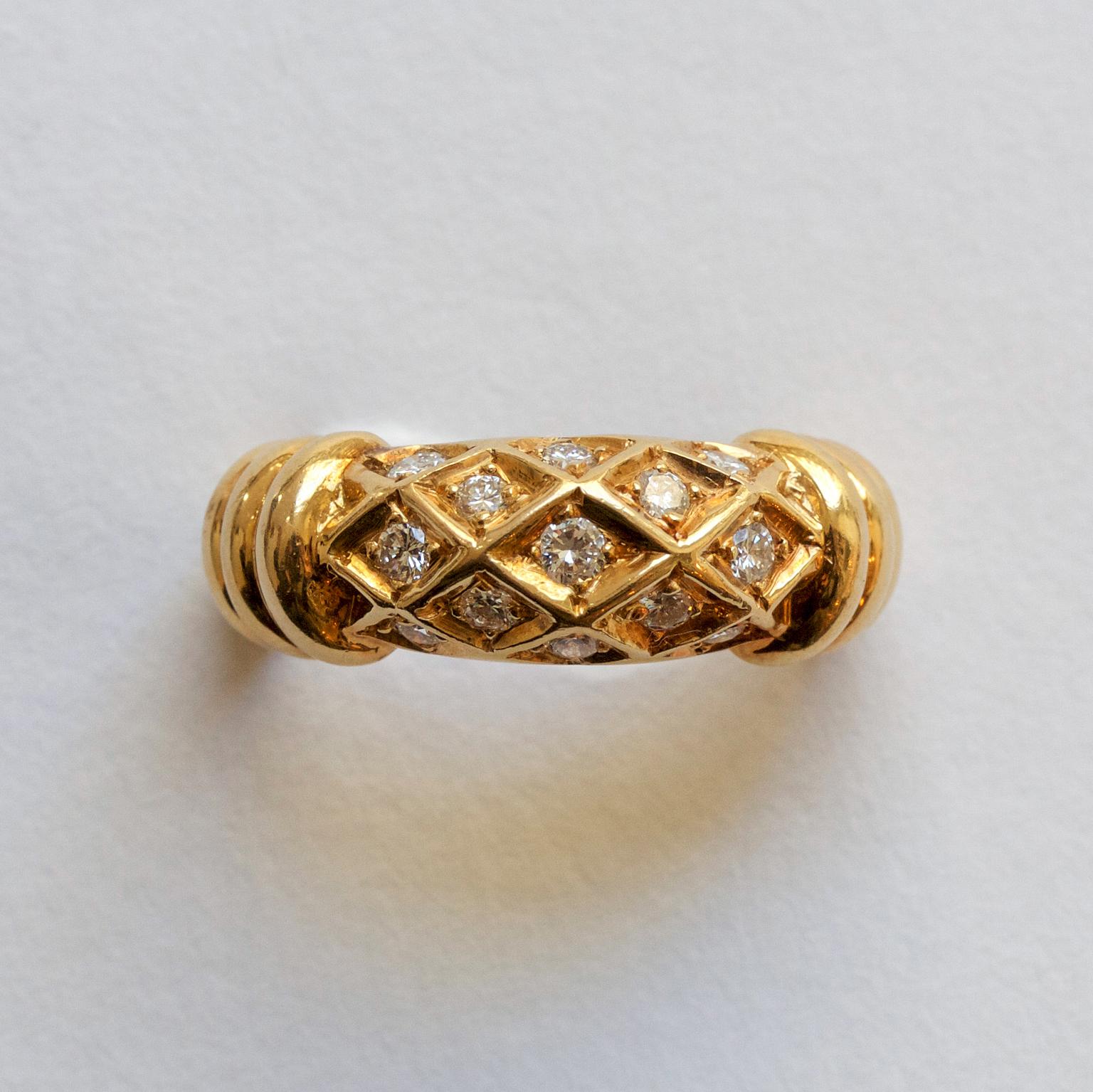 An 18 carat gold ring set with thirteen brilliant cut diamonds in kite shape with ribbed to the side of the shank, signed and numbered: 26810950. France, circa 1985.

weight: 7.2 grams
ring size: 15 ¼ / 4.5 US
width: 3.8 tot 7 mm