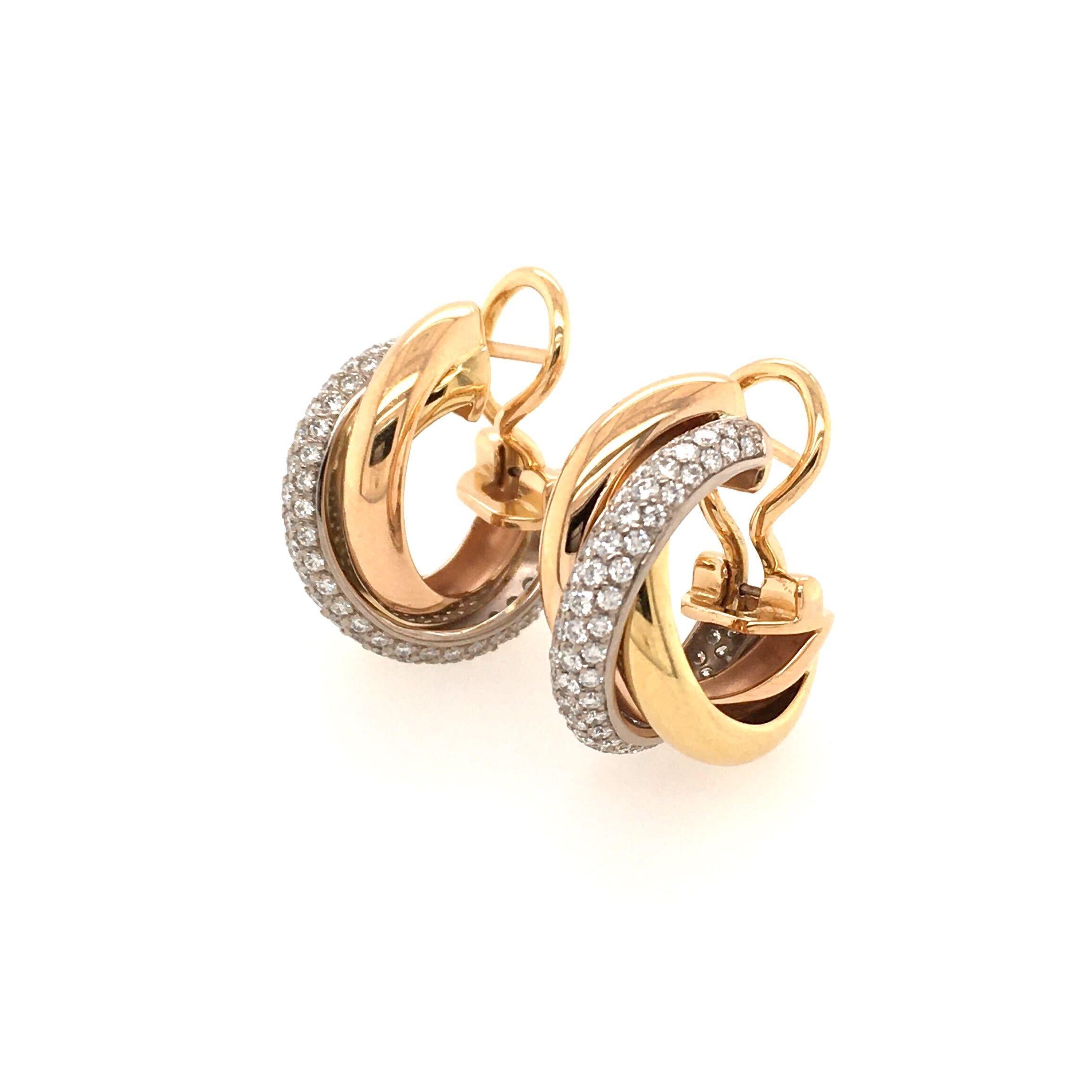 A pair of 18 karat rose, yellow  and white gold and diamond Trinity. earrings. Cartier. Designed as a small hoop, enhanced by pave set diamonds. Seventy one (71) diamonds weigh approximately 0.80 carat. Length is approximately 3/4 inches, gross