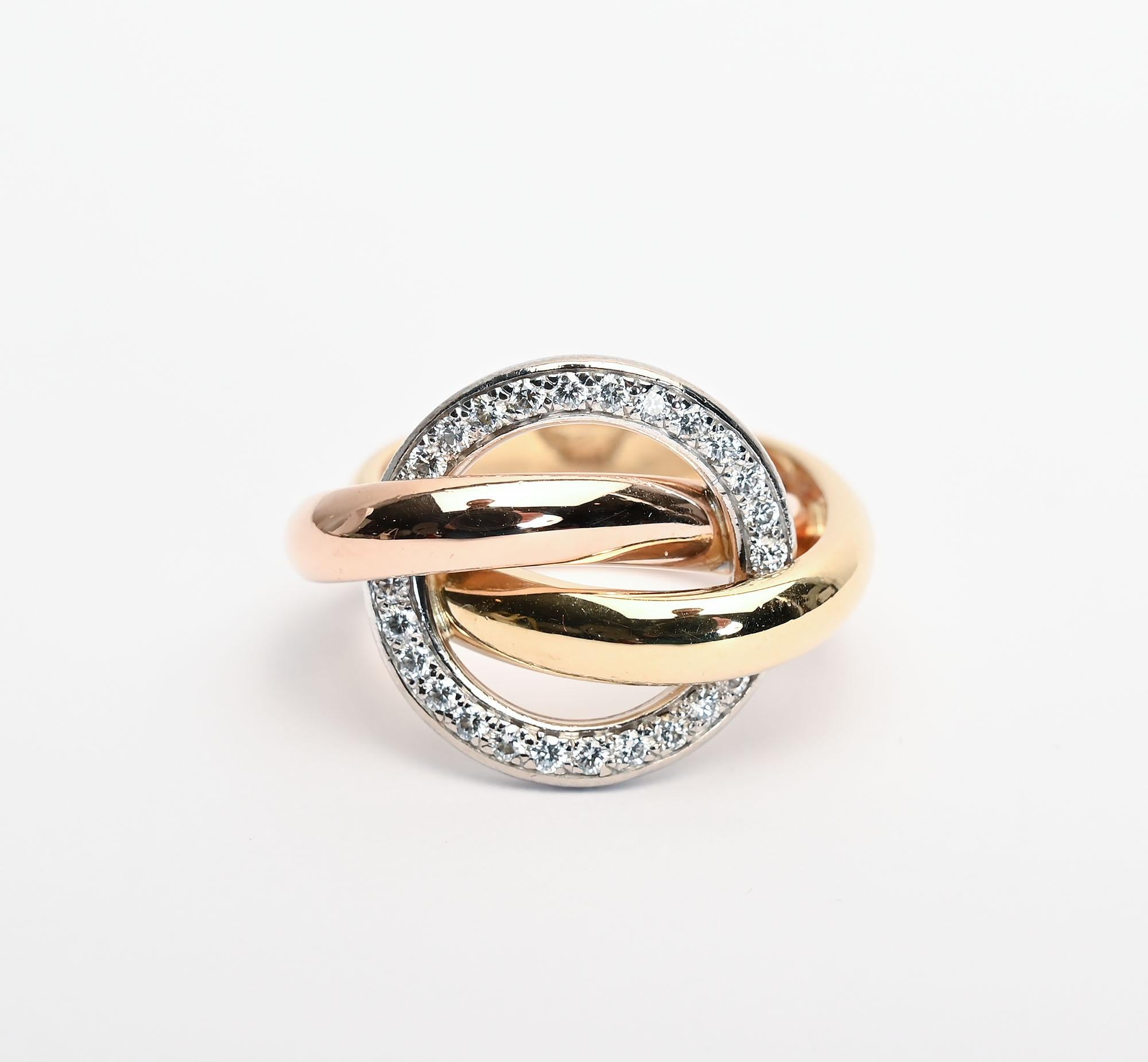 Chic and unusual gold and diamond ring by Cartier. The gold bands are yellow and rose gold. The circle of diamonds is 3/4 inch in diameter. The ring is size 6/34; it can be sized by a capable jeweler. This fashionable ring can be worn equally well
