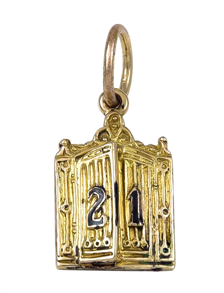 Gold charm:  a figural rendering of the door of the iconic 