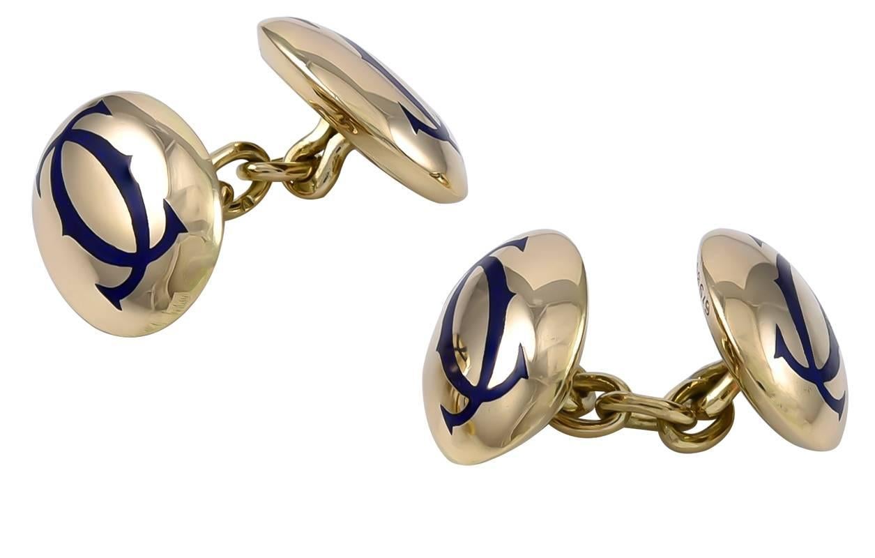 Very attractive oval double-sided cufflinks.  Made, signed and numbered by CARTIER.  18K yellow gold;  black enamel with the interlocking 
