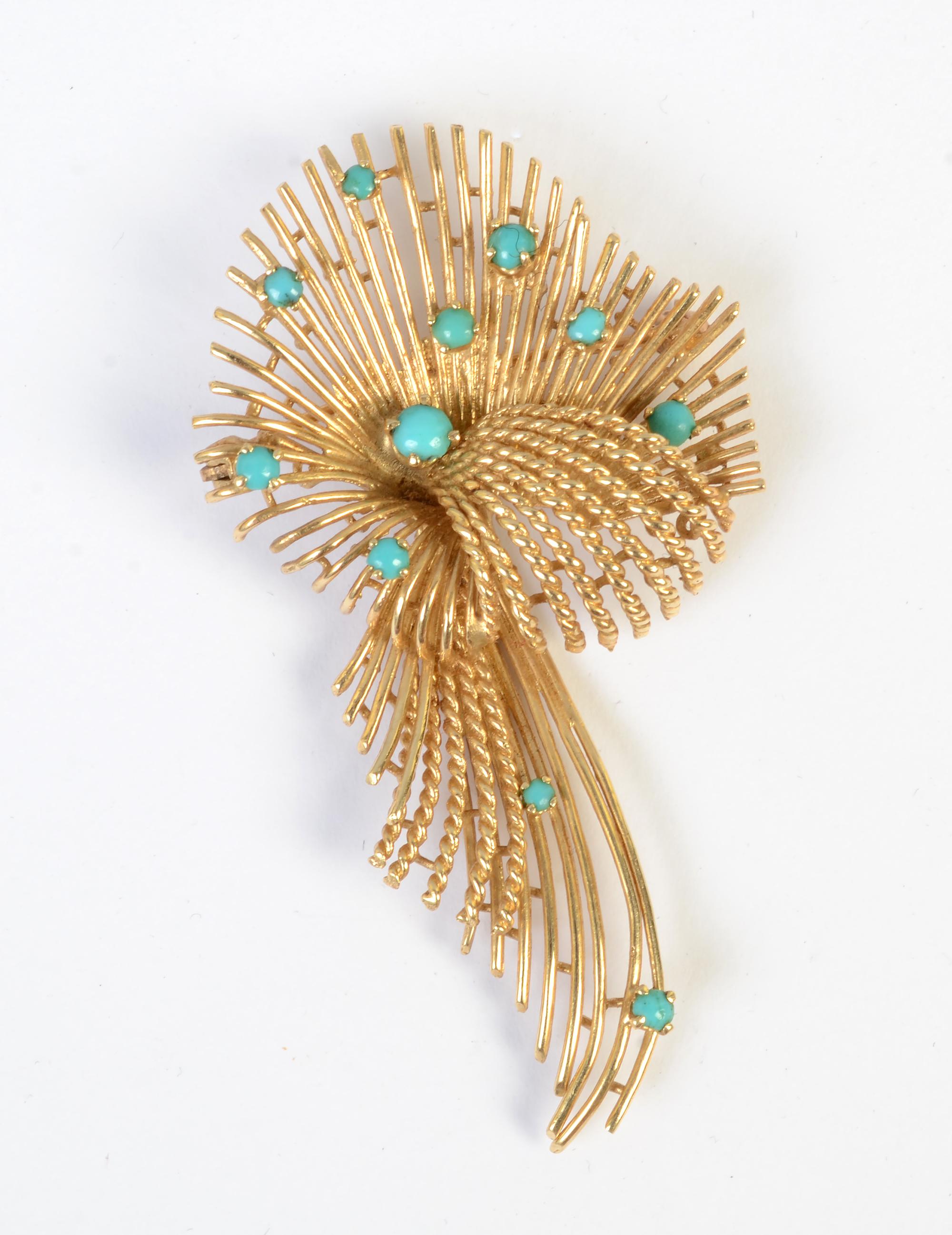 Graceful curved spokes of gold create an effect of a wafting ribbon or bow. The gold is both smooth and twisted adding to light, airy feel. Nine cabochon turquoise stones add just the right amount of color.
The brooch is 2 3/8