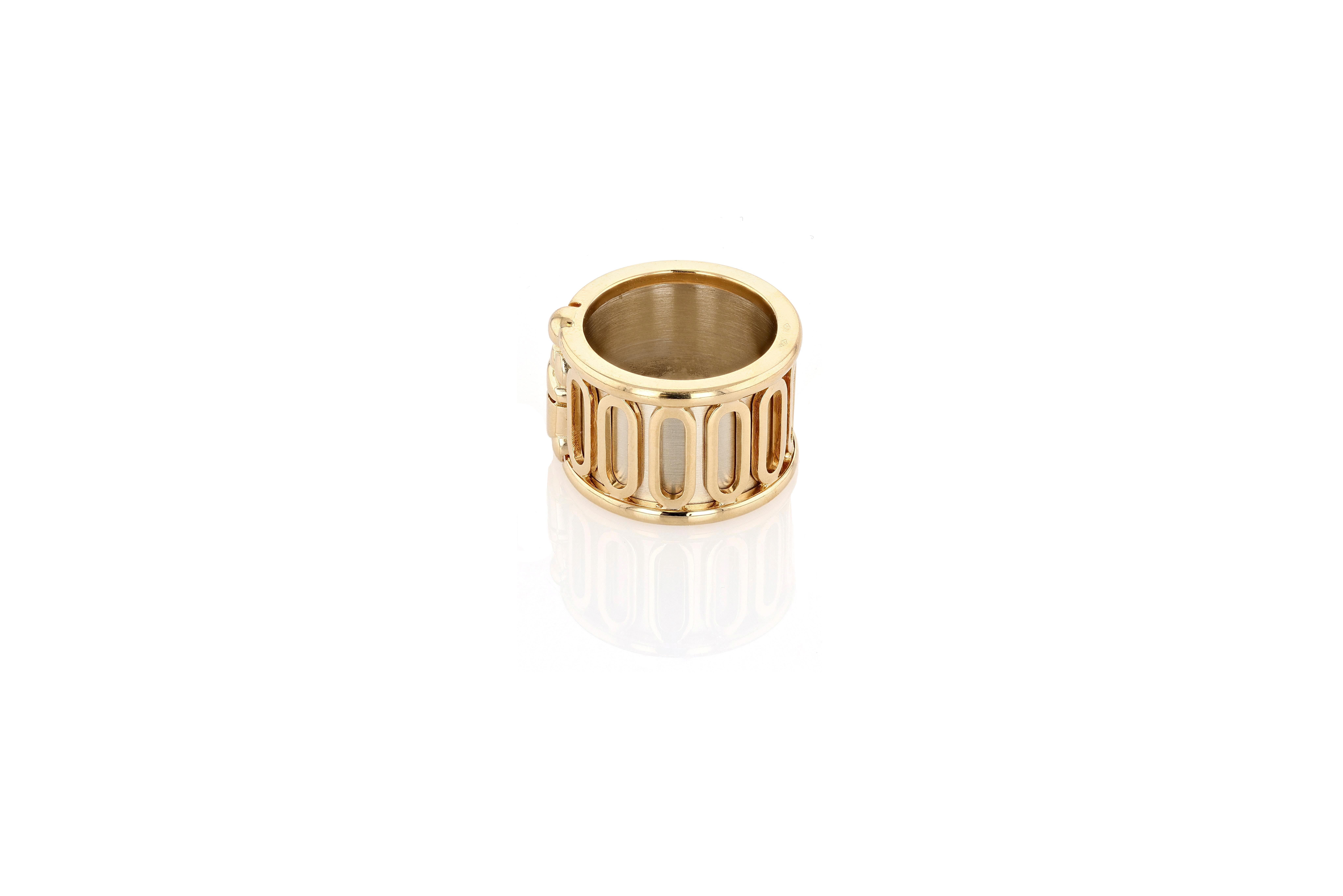 A rare 18 karat yellow and white gold wide Scarab ring from Cartier. The white gold band of the ring features a satin finish and is overlaid with the scarab motif and the open loops in high polish yellow gold. The ring is size 6, and its width is