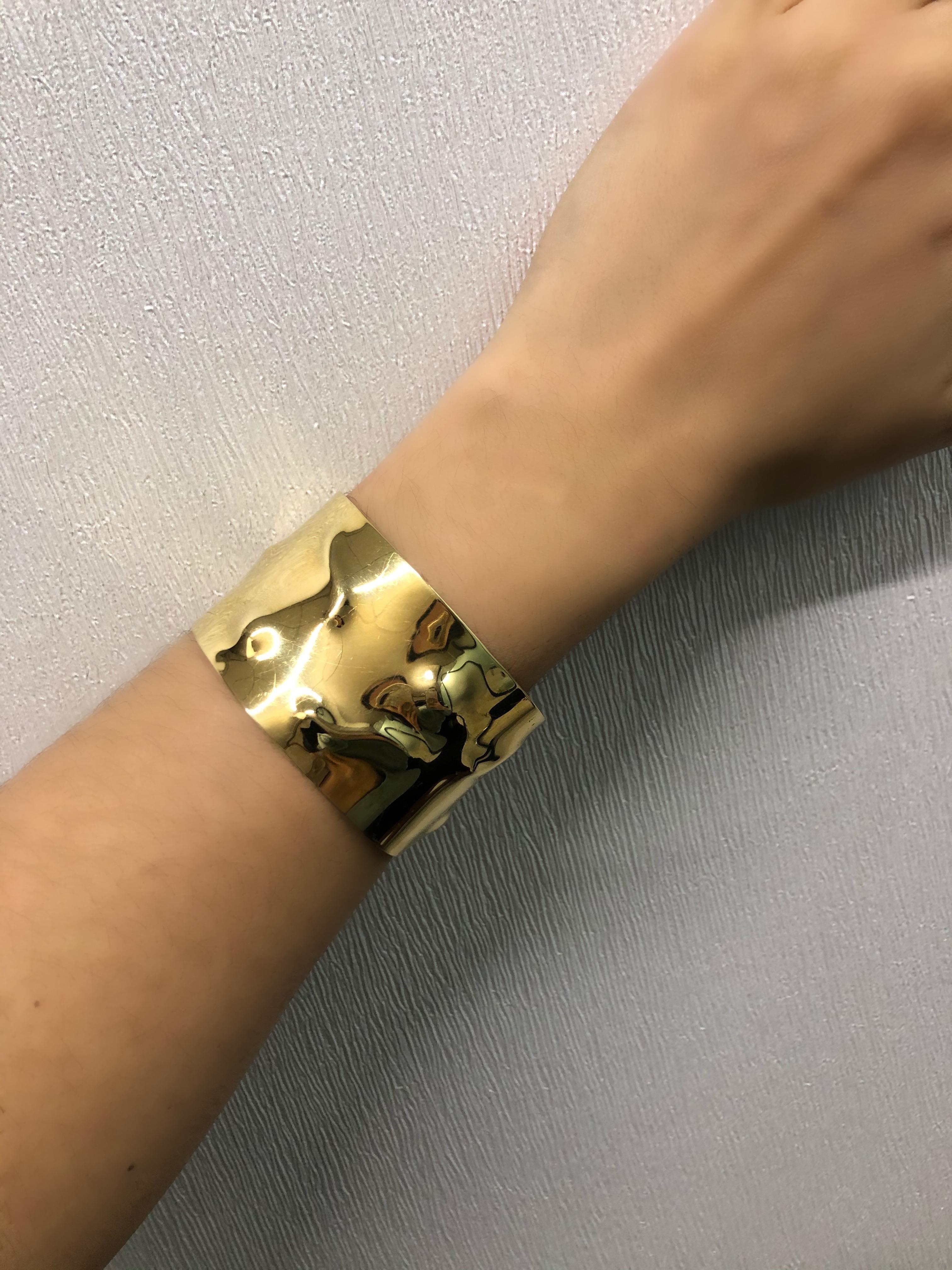 This cuff bracelet features 18 kt., of polished abstract design gold. Signed Cartier. Approximately 50 grams. Inner circle 6 1/2 inches. Width 1 1/2 inches. 

Viewings available in our NYC showroom by appointment.