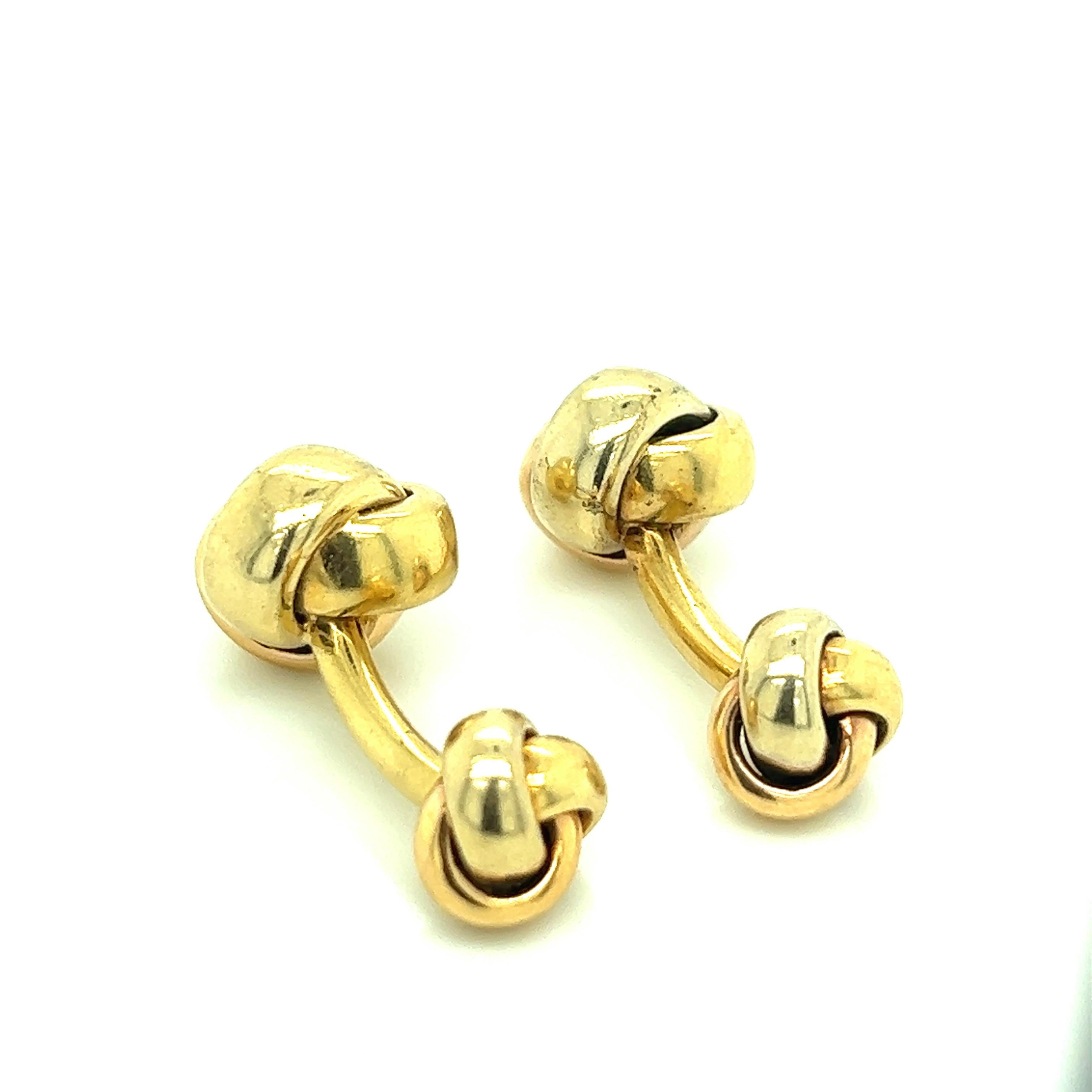Cartier 18 karat yellow gold cufflinks with a knot motif. Marked: Cartier / 750. Total weight: 19.1 grams. Width: 0.5 inch. Length: 1.13 inch. 