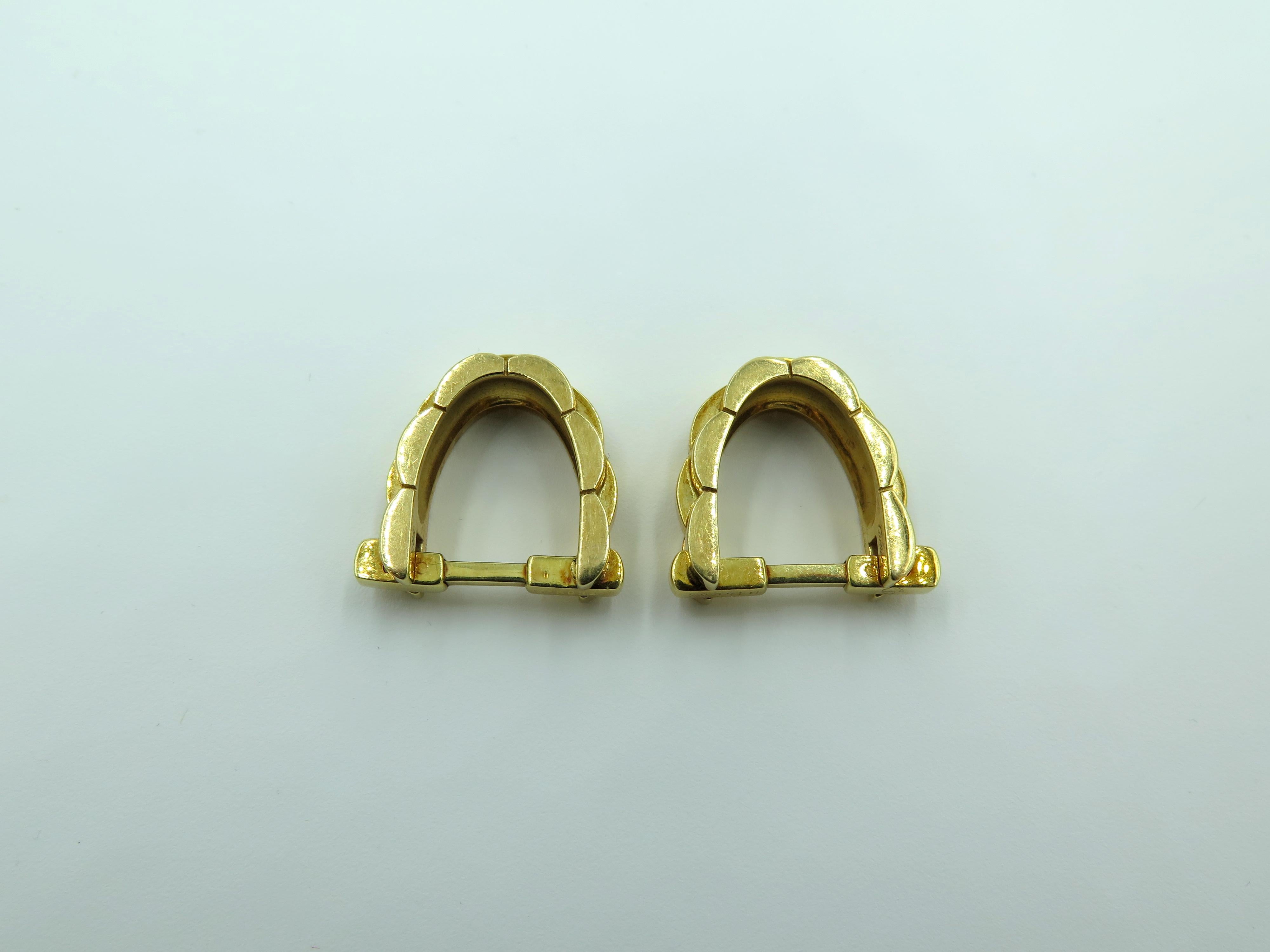 A pair of 18 karat yellow gold cufflinks.  Cartier.  From the Panthere collection. Of  stirrup design. Length is approximately 3/4 inches, gross weight is approximately 17.4 grams. Stamped Cartier, 750, with maker’s mark. numbered M15934. 