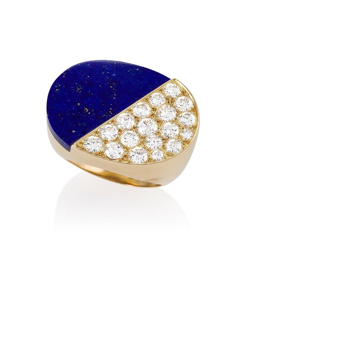 A French 18 karat gold ring with diamonds and lapis lazuli by Cartier. The sizable ring features a flat oblong crown, diagonally split between a sold piece of lapis lazuli and pavé-set diamonds. The ring has 18 round diamonds with an approximate