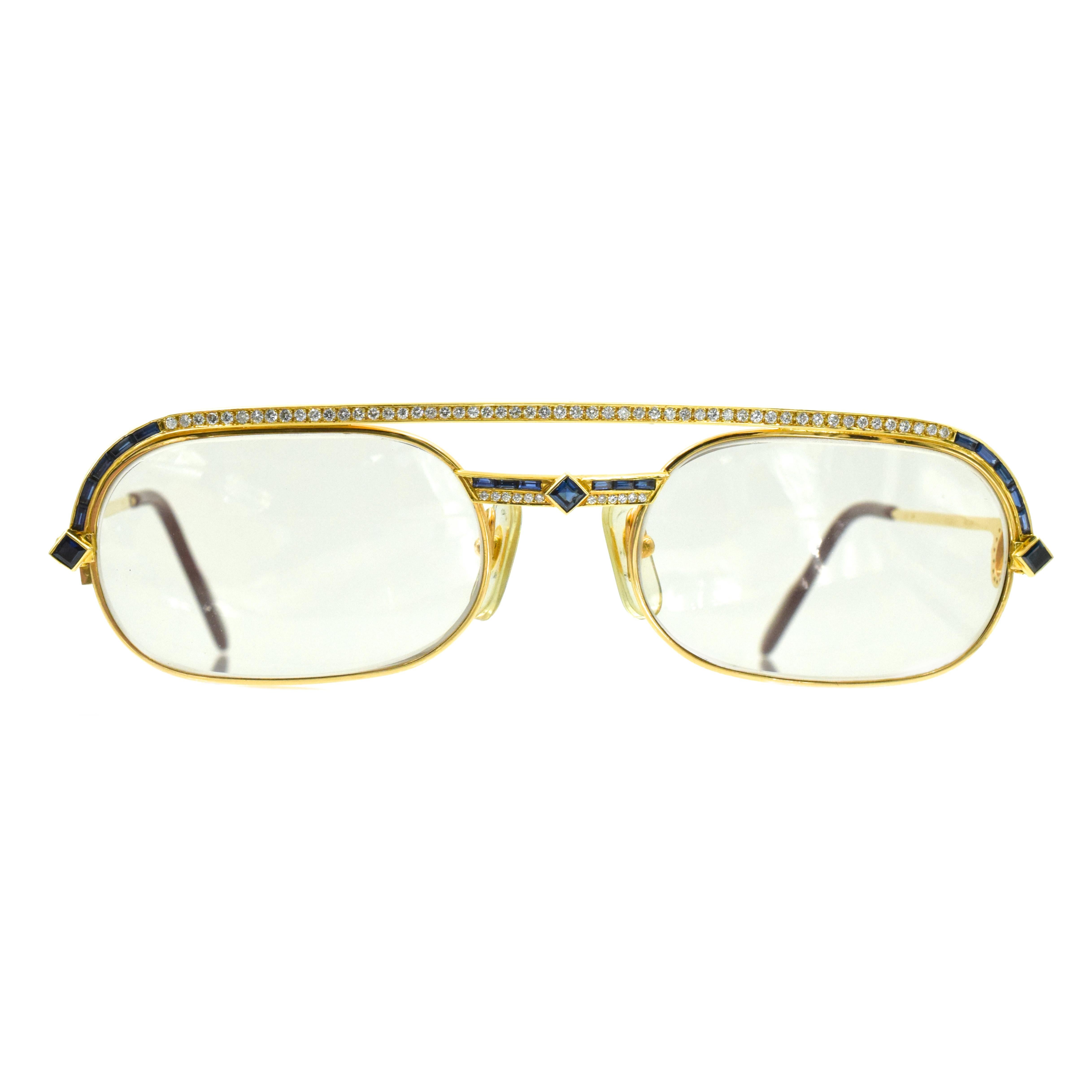 Cartier gold, diamond and sapphire eyeglasses
The gold frames accented on the top and center with round diamonds, further highlighted with square and calibré-cut sapphires, the sides decorated with C-motifs pavé-set with round diamonds. 
 Diamonds