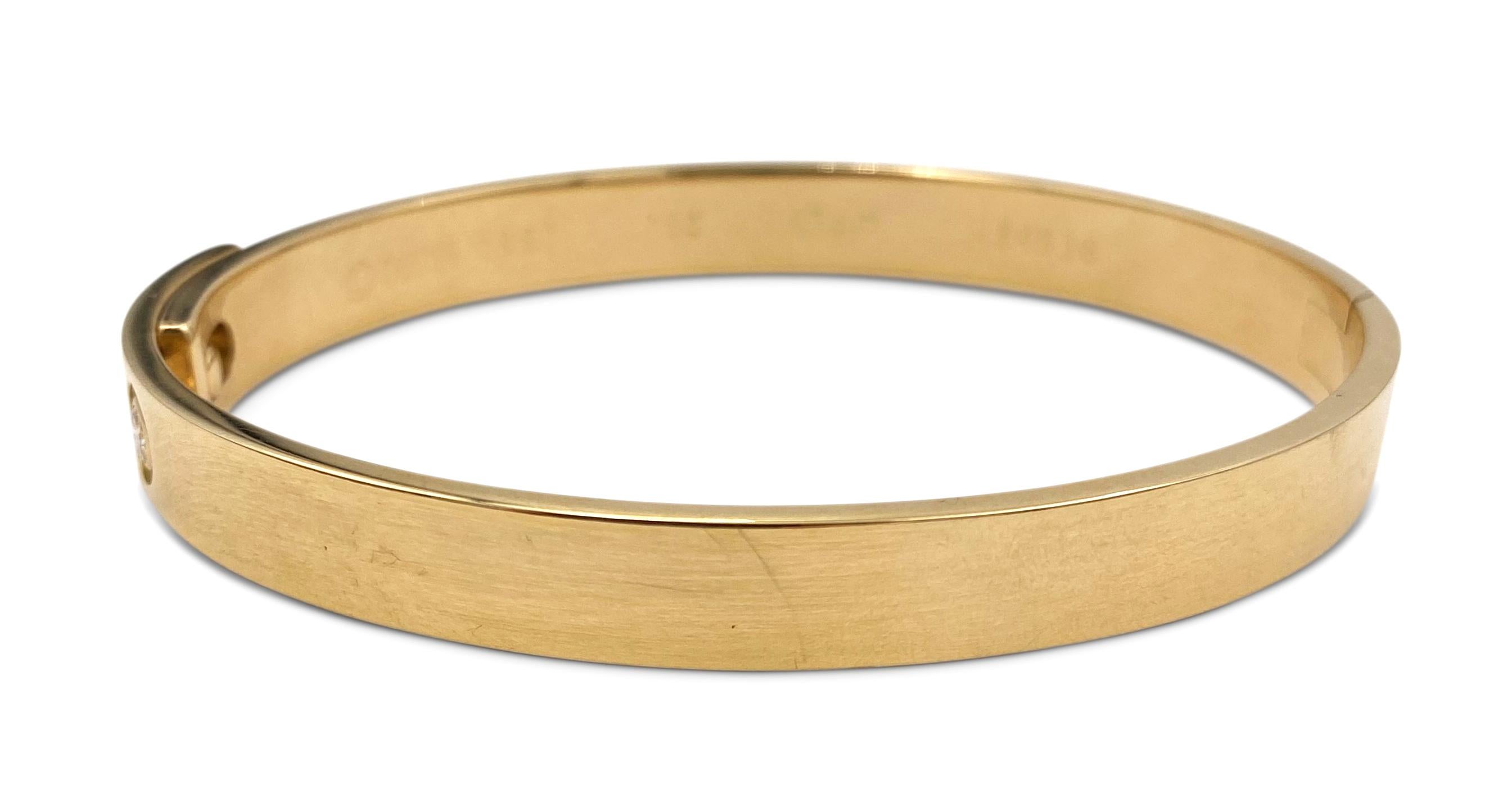 Authentic Cartier Anniversary bracelet crafted in 18 karat yellow gold and featuring 1 round brilliant diamond weighing approximately .10ct.  Size 17.  Signed Cartier, 1997, 750, 17cm, with serial number and hallmarks.  Does not come with Cartier