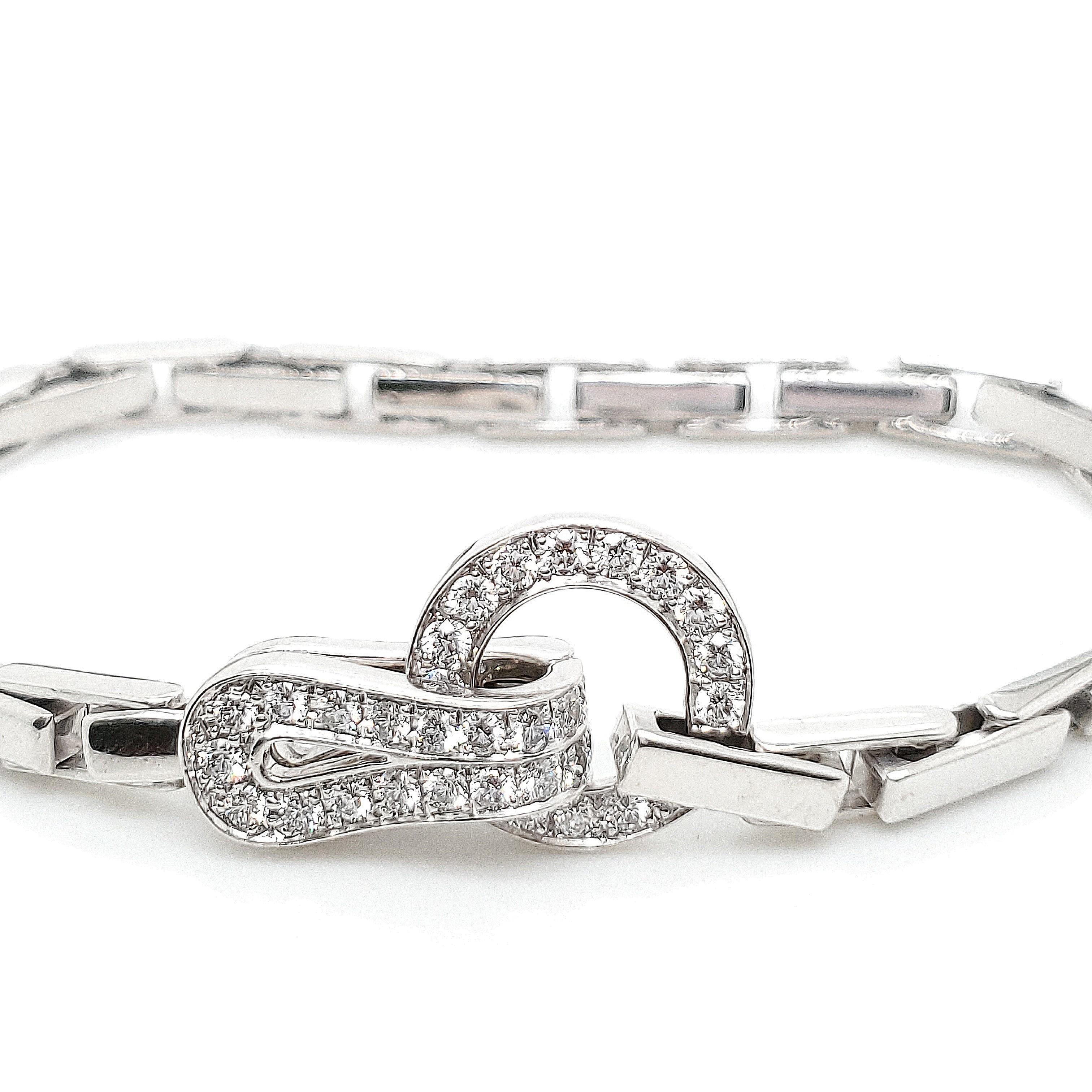 Authentic Cartier 'Agrafe' bracelet crafted in 18 karat white gold. The hook shape clasp looks like an “Agrafe” as it means in French a clasp or hook. Clasp is set with approx. 1.05 carats of round brilliant cut diamonds (F color, VS clarity).