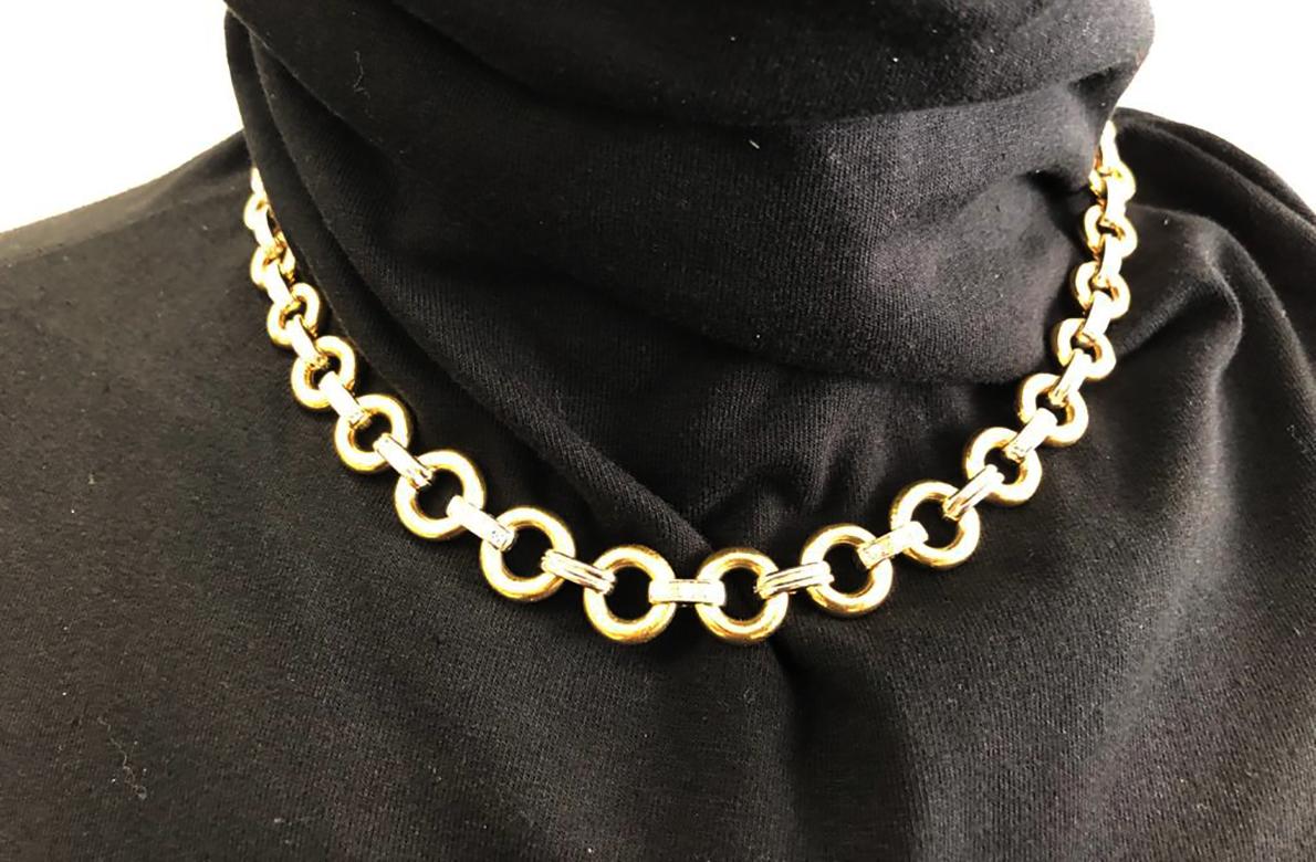 CARTIER Diamond Link Necklace in 18k Yellow and White Gold.
A weighty yet wearable link chain by Cartier dating from the 1980s. This vintage necklace features solid circular rims of yellow gold joined with fluted white gold links intermittently