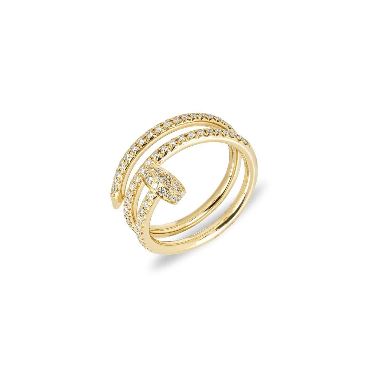 An 18k yellow gold double diamond ring by Cartier from the Juste Un Clou collection. The ring is in the style of a nail wrapping around the finger, set with round brilliant cut diamonds to the front sections. There are 77 diamonds with a total