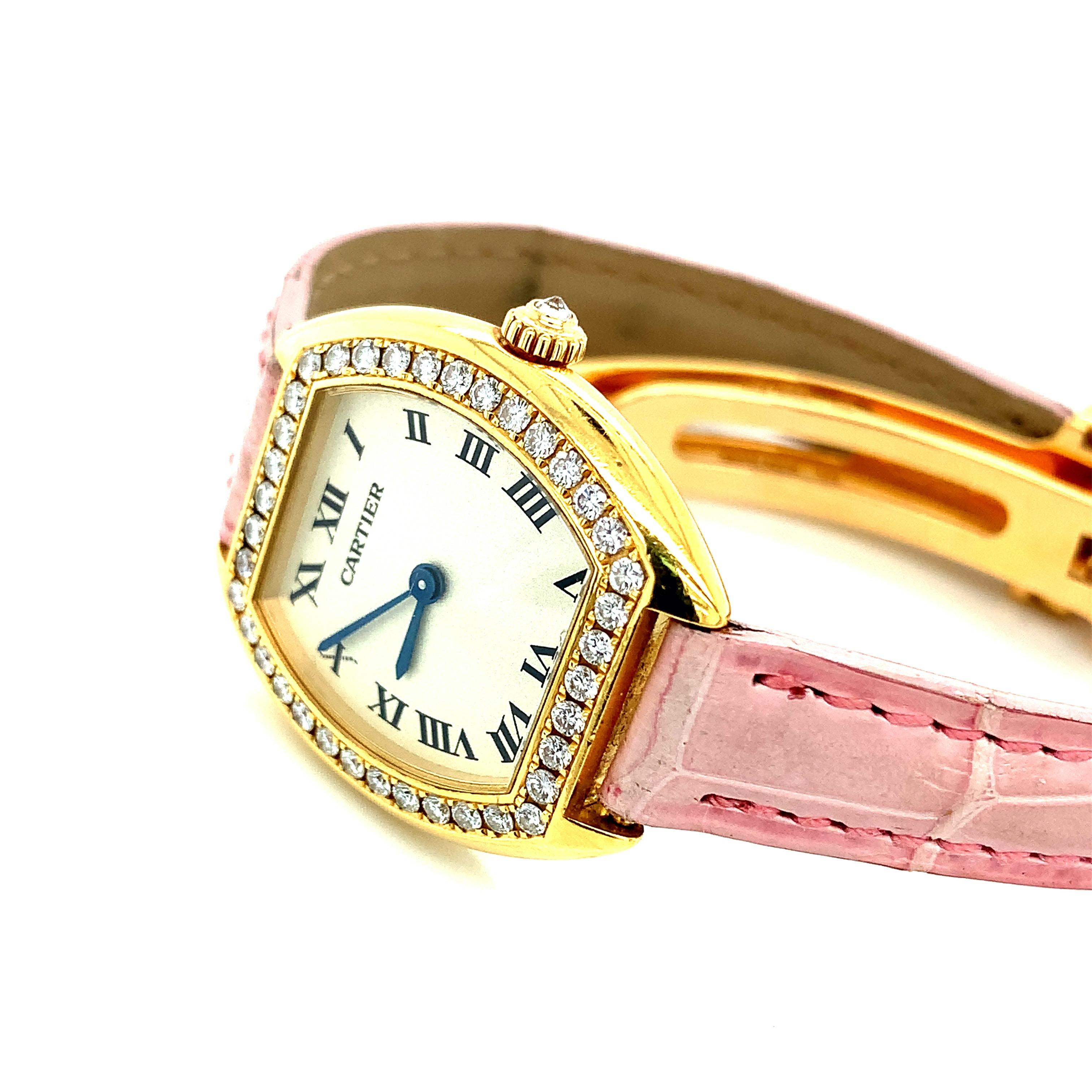 Cartier 18 karat yellow gold wristwatch with pink leather bands. Made in Switzerland, 1945. Serial no. MG214956. Marked: Cartier / Water Resistant / Swiss made / 18K / 1945 / MG214956. Total weight: 35.4 grams. Case measurements: width 2.4 cm,