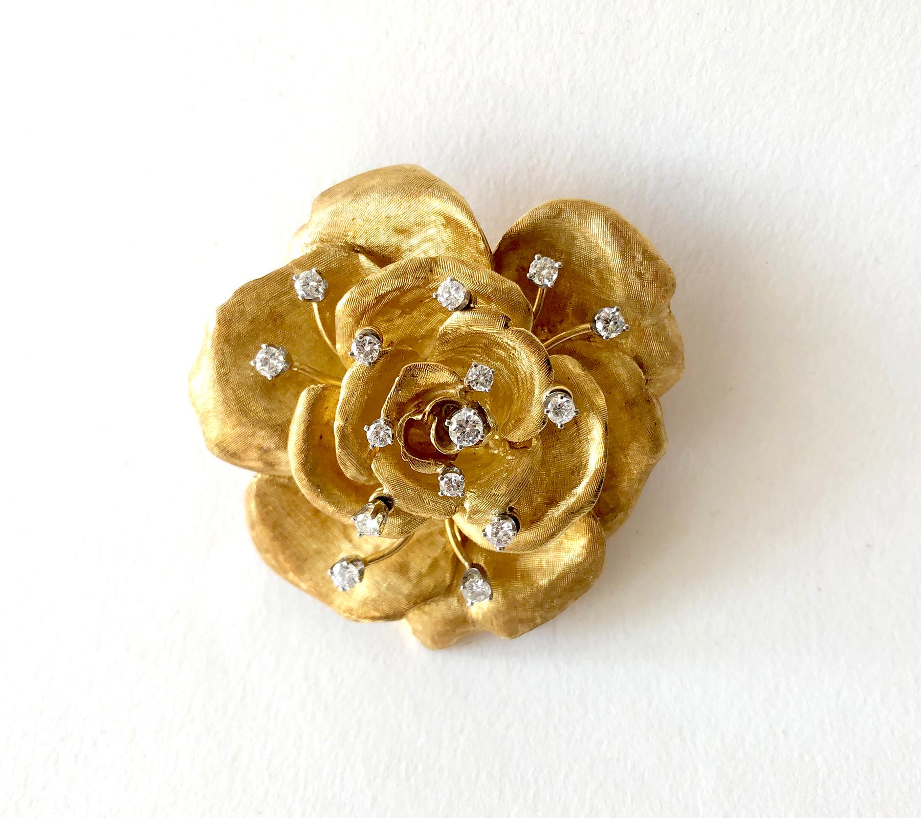 An 18 karat gold and diamond rose flowering brooch and matching earrings created by Cartier of France. The set has a Florentine finish to the petals with 15 full cut diamonds in the brooch, some of them en tremblant. The earrings have one single