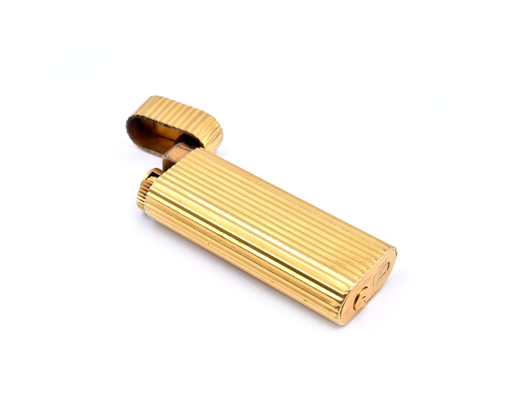 Designer: Cartier
Material: sterling silver
Dimensions: lighter is approximately 69.60mm x 25.35mm x 12.70mm
Weight: 85.64 grams
