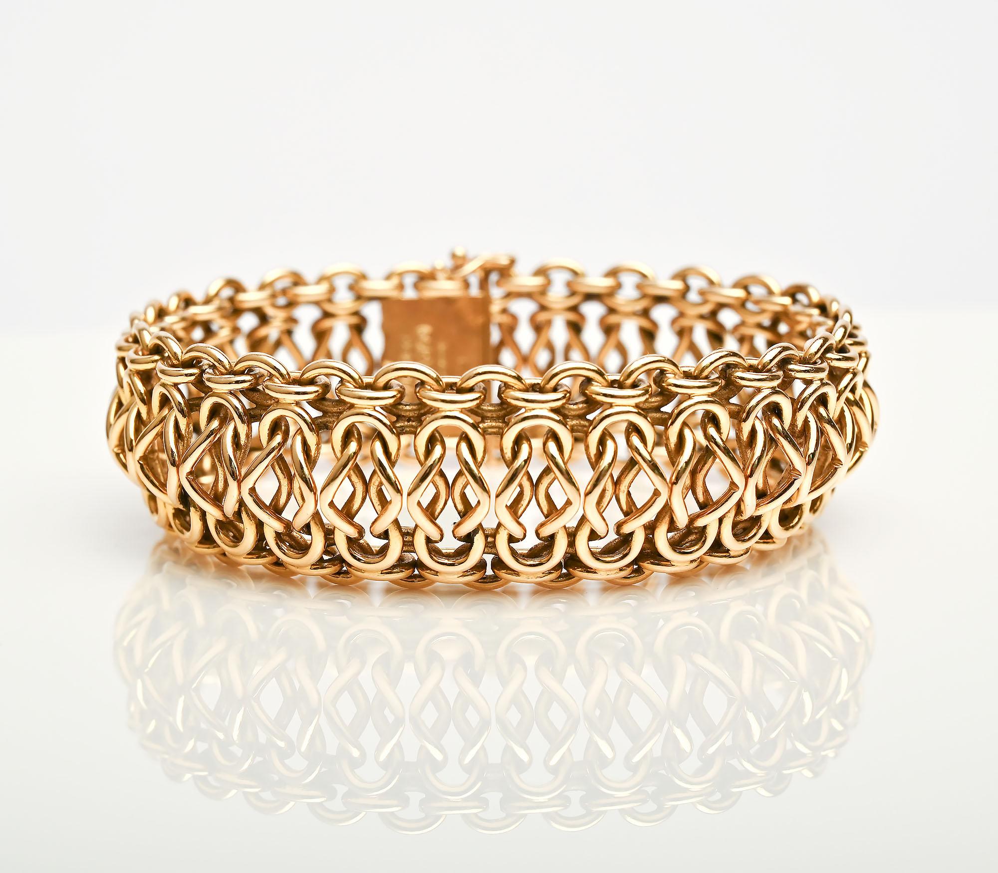 Cartier bracelet with intricate 18 karat gold links. The links create a  three dimensional design of ovals and figure eights. The bracelet measures 13/16