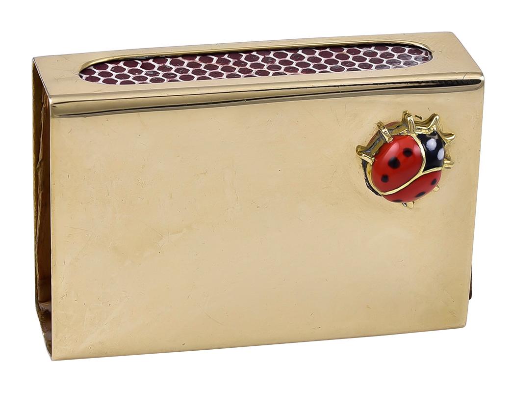 Gold match box with striker, with an applied red and black enamel figural 