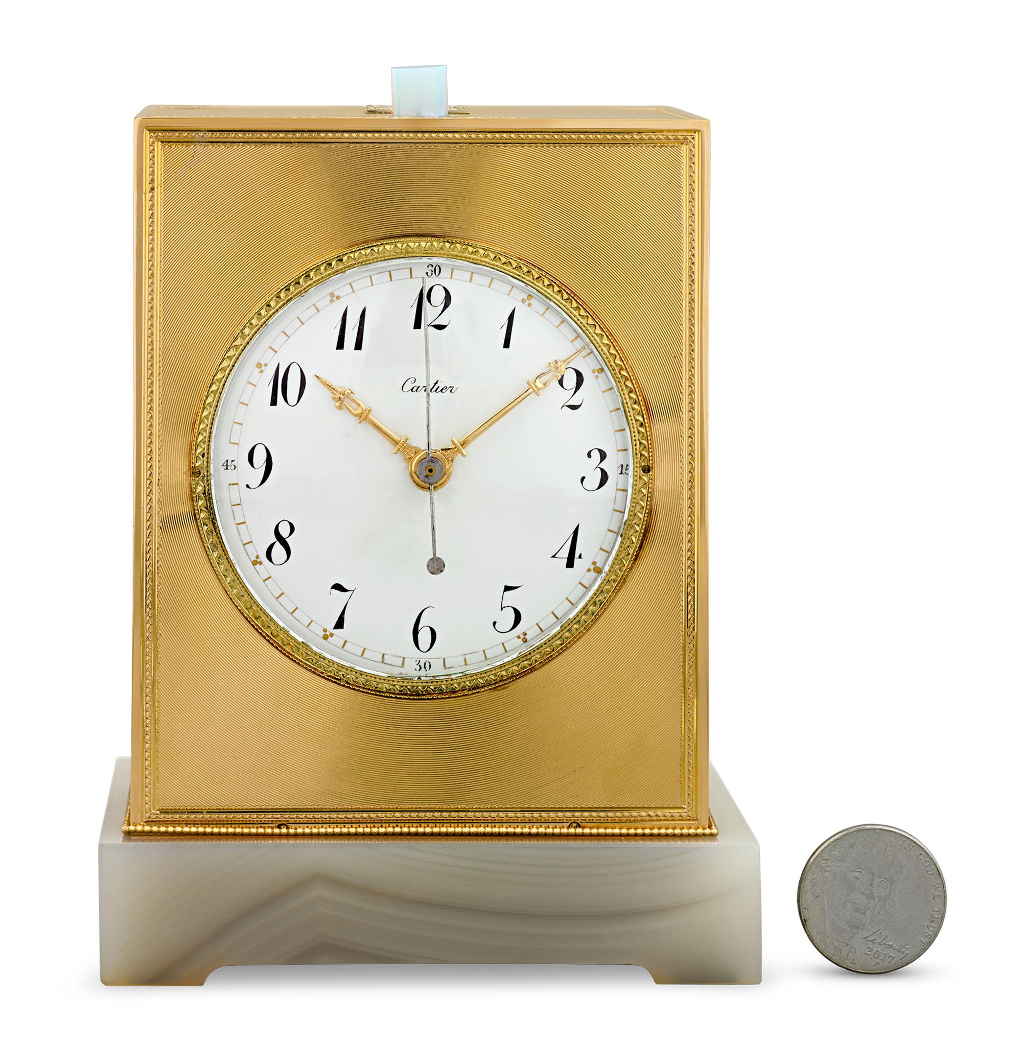 This minute repeater carriage clock by the esteemed Cartier is a masterpiece of luxury and craftsmanship created circa 1900. Finished in gold, diamonds and cabochon moonstone with an agate base, this exquisite clock is one of the few minute