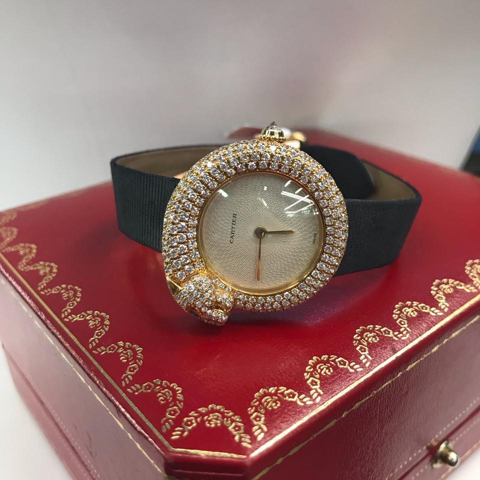 SIGNED CARTIER, PANTHERE 1925 MODEL, REF. 2309, CASE NO. DM10536, CIRCA 2005
Quartz movement, cream engine-turned dial, circular case, emerald-eyed panther-form bezel and band with pave-set diamonds, back secured by four screws, diamond-set crown,