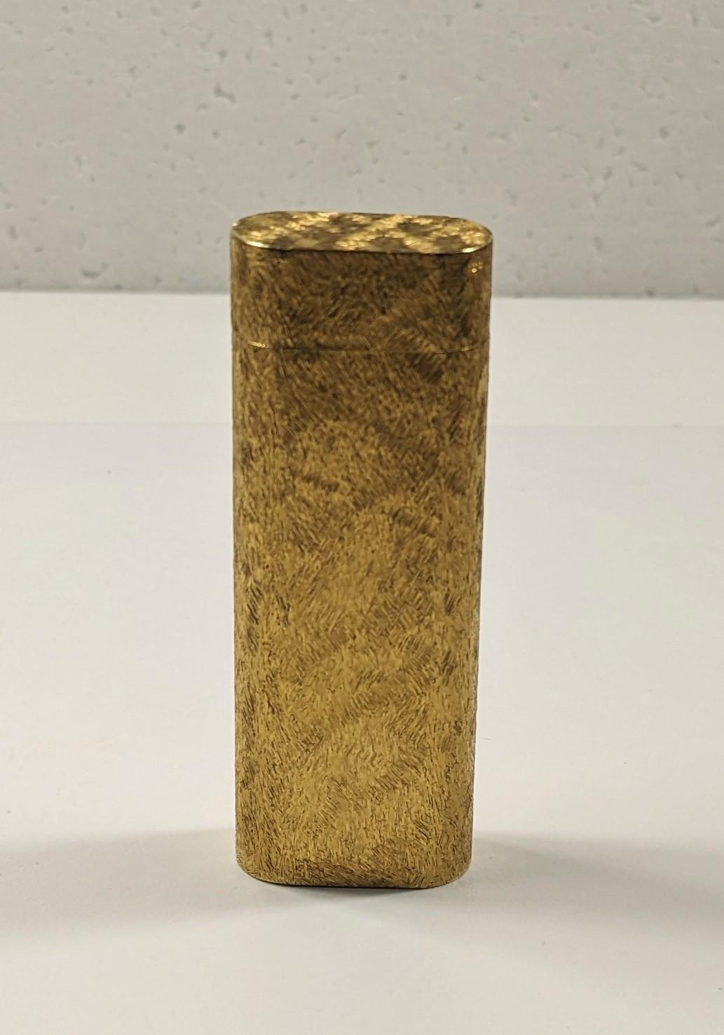  Cartier Gold Plate Feuerzeug Paris 822777, ovaler Querschnitt mit Mineralstruktur Dekor

Sie hat einen verstellbaren Deckel, in dem der in der Schweiz hergestellte Mechanismus untergebracht ist. 
Sie ist sowohl auf dem Deckel als auch auf dem Boden