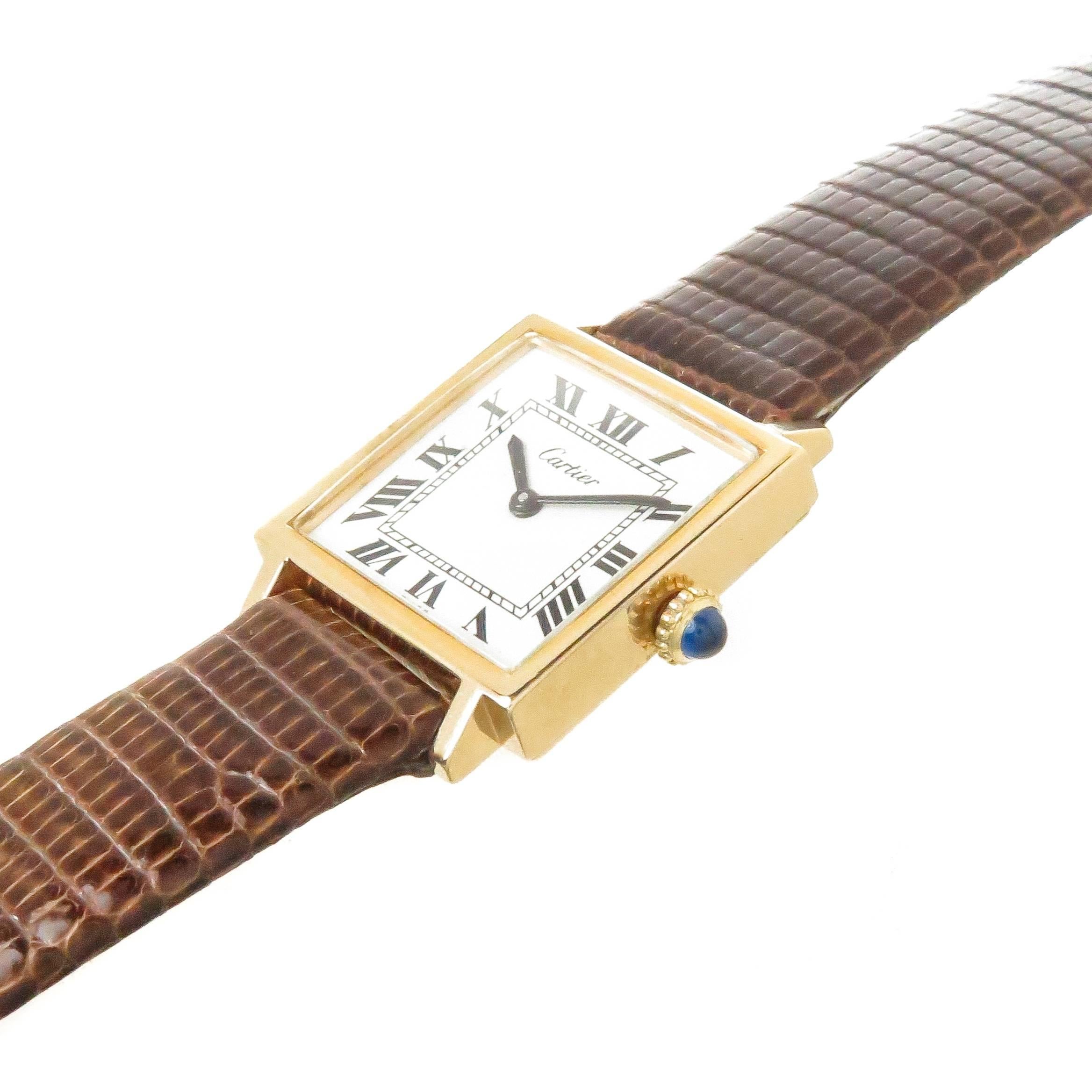 Circa 1970s Cartier Tank Wrist watch, 29 X 22 MM Gold Plate 2 piece case. Mechanical, manual wind 17 Jewel Cartier Movement. White Dial with Black Roman Numerals. New brown Lizard strap with Gold Plated Tang Buckle, watch length 8 1/4 inches.. 