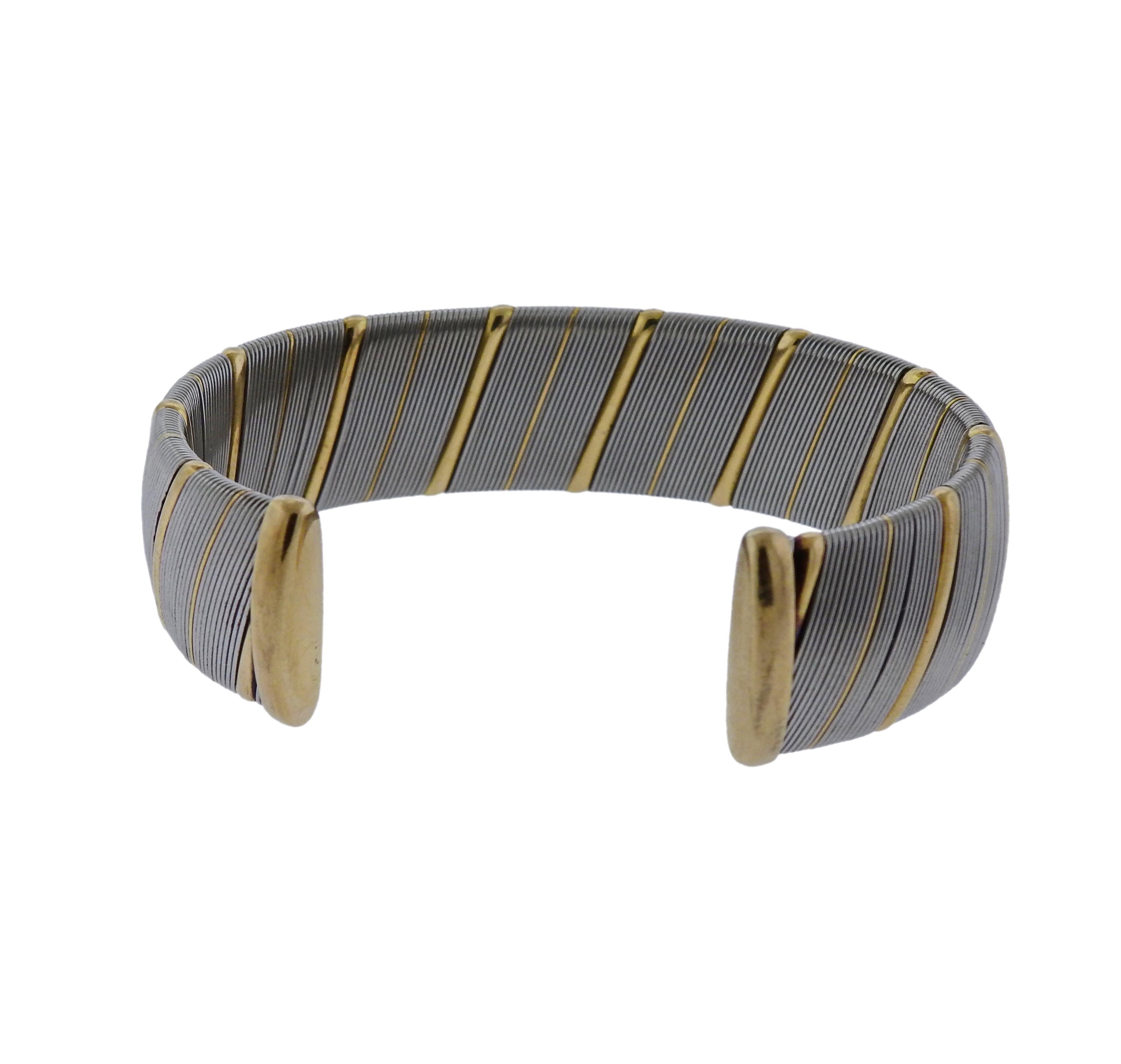 Stainless steel and 18k yellow gold bracelet crafted by Cartier. Bracelet will fit approx. 7.5