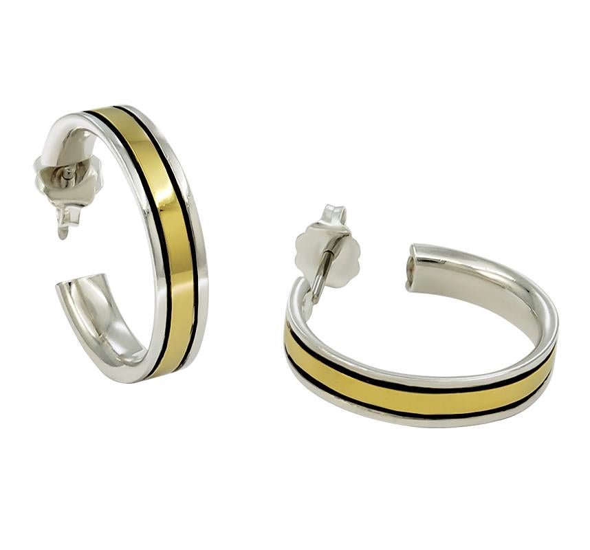 Classic hoop earrings.  Made and signed by CARTIER.  Sterling silver and 18K yellow gold.  2/3
