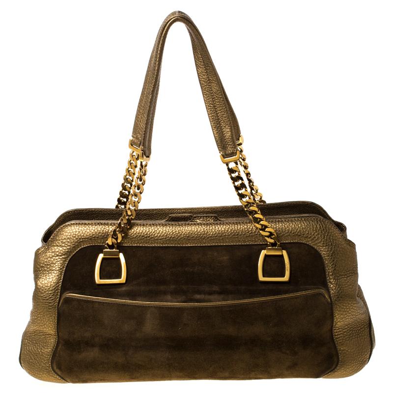 This La Dona bag from Cartier is gorgeous. The gold beauty is crafted from suede and leather and flaunts a distinctive style. Equipped with dual handles, the bag features a pocket on the front. The top closure opens to a fabric-lined interior and