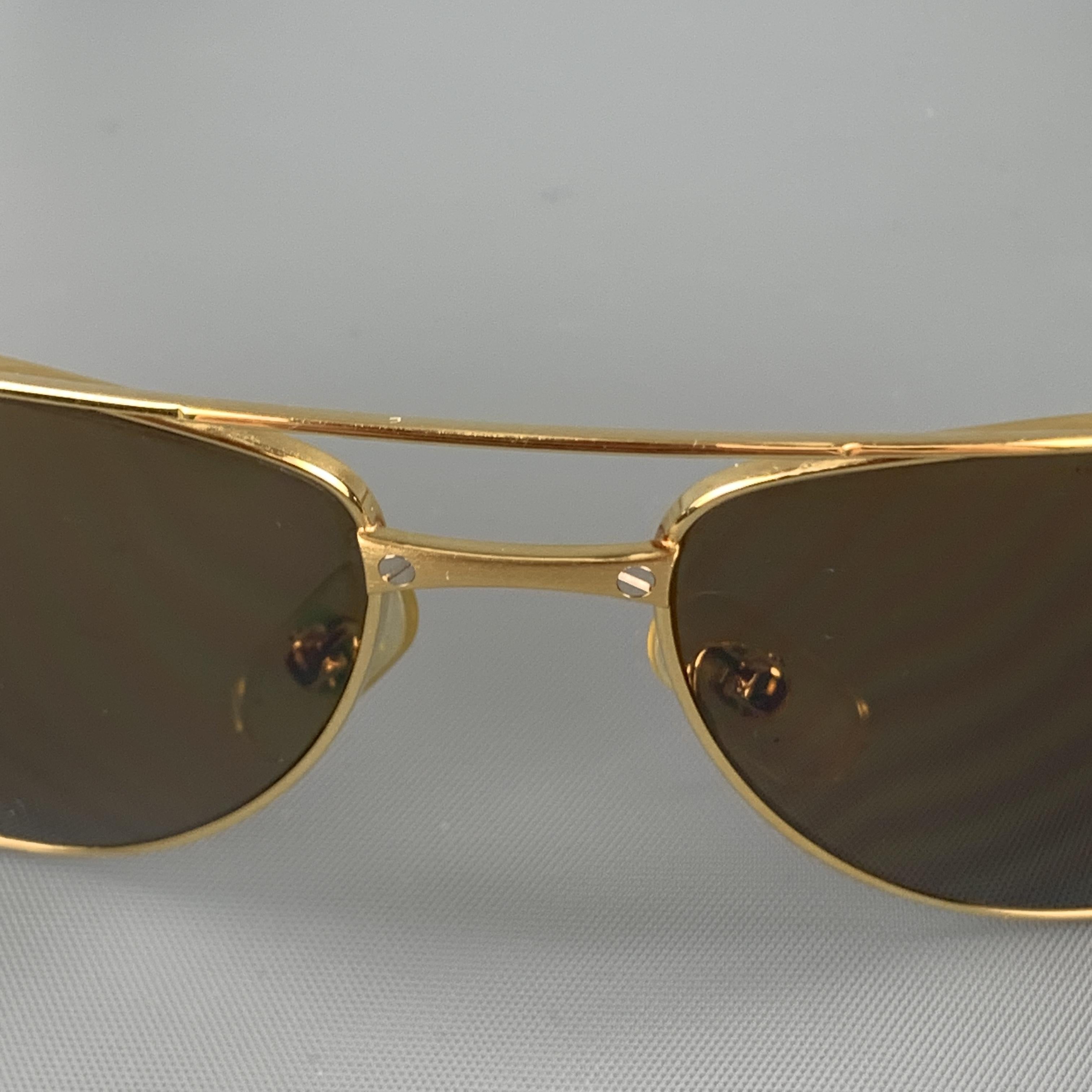 CARTIER Santos-Dumont aviator sunglasses come in brushed gold tone metal with brown lenses and screw details throughout. Made in France.

Very Good Pre-Owned Condition.
Marked: 3812536

Measurements:

Length: 14.5 cm.
Height:  4.5 cm.