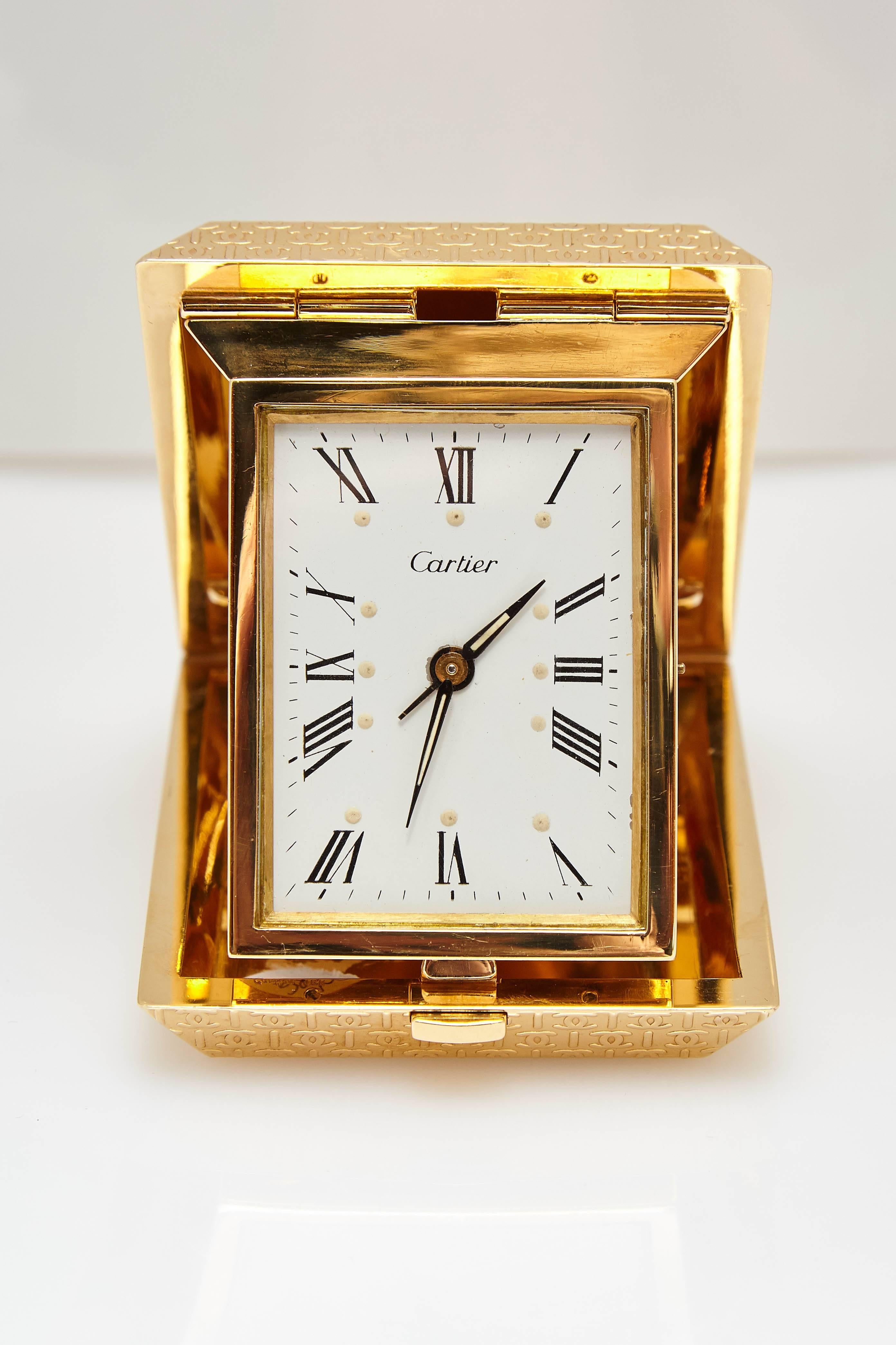 Cartier folding travel clock (with alarm) in 18kt yellow gold. Made in France, circa 1960.