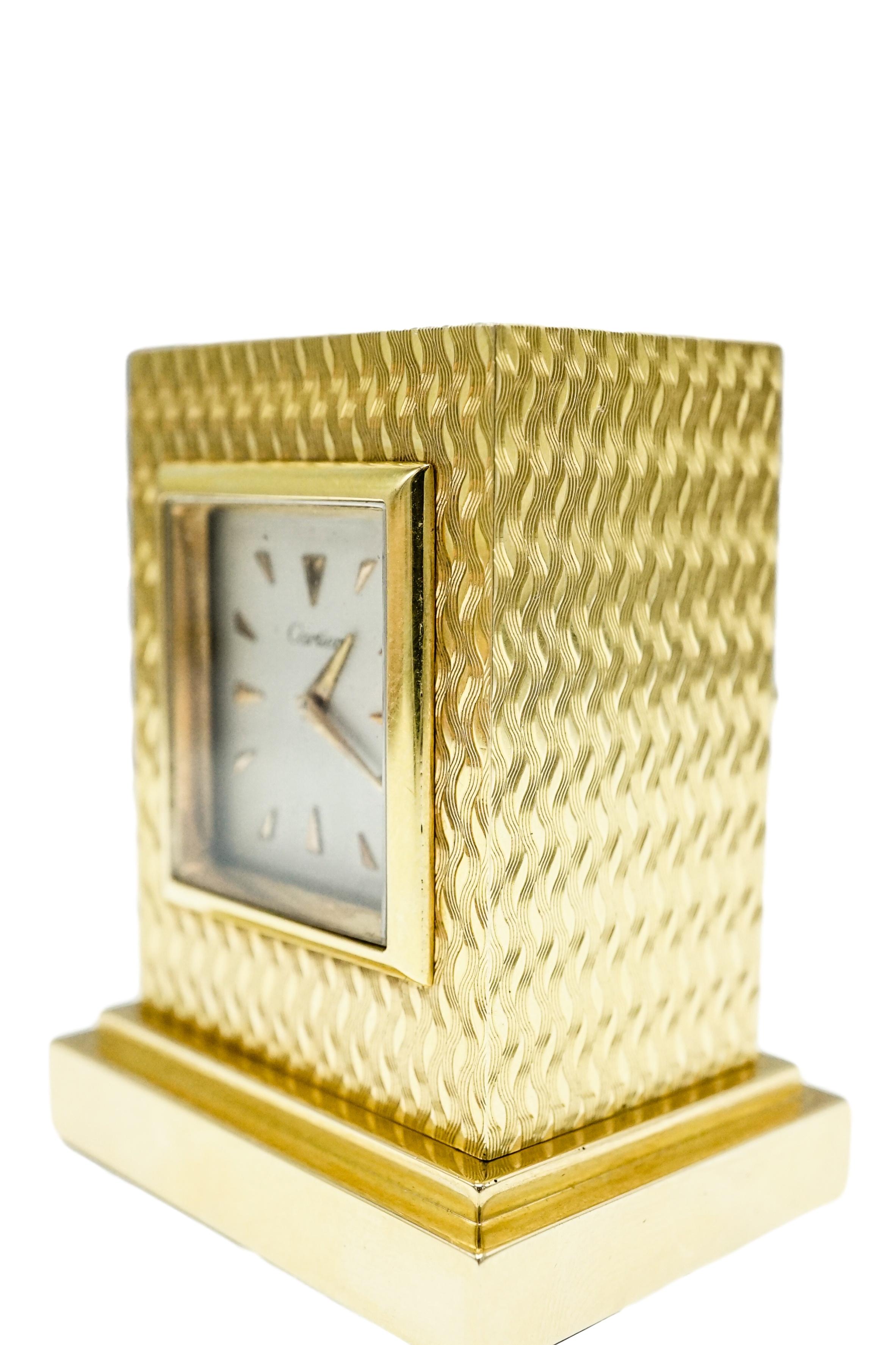 Cartier, Rectangular outline, gold, mechanical movement, 1 5/8 x 1 ¼ x 2 1/8 ins., signed Cartier, movement by Geneva Clock Company