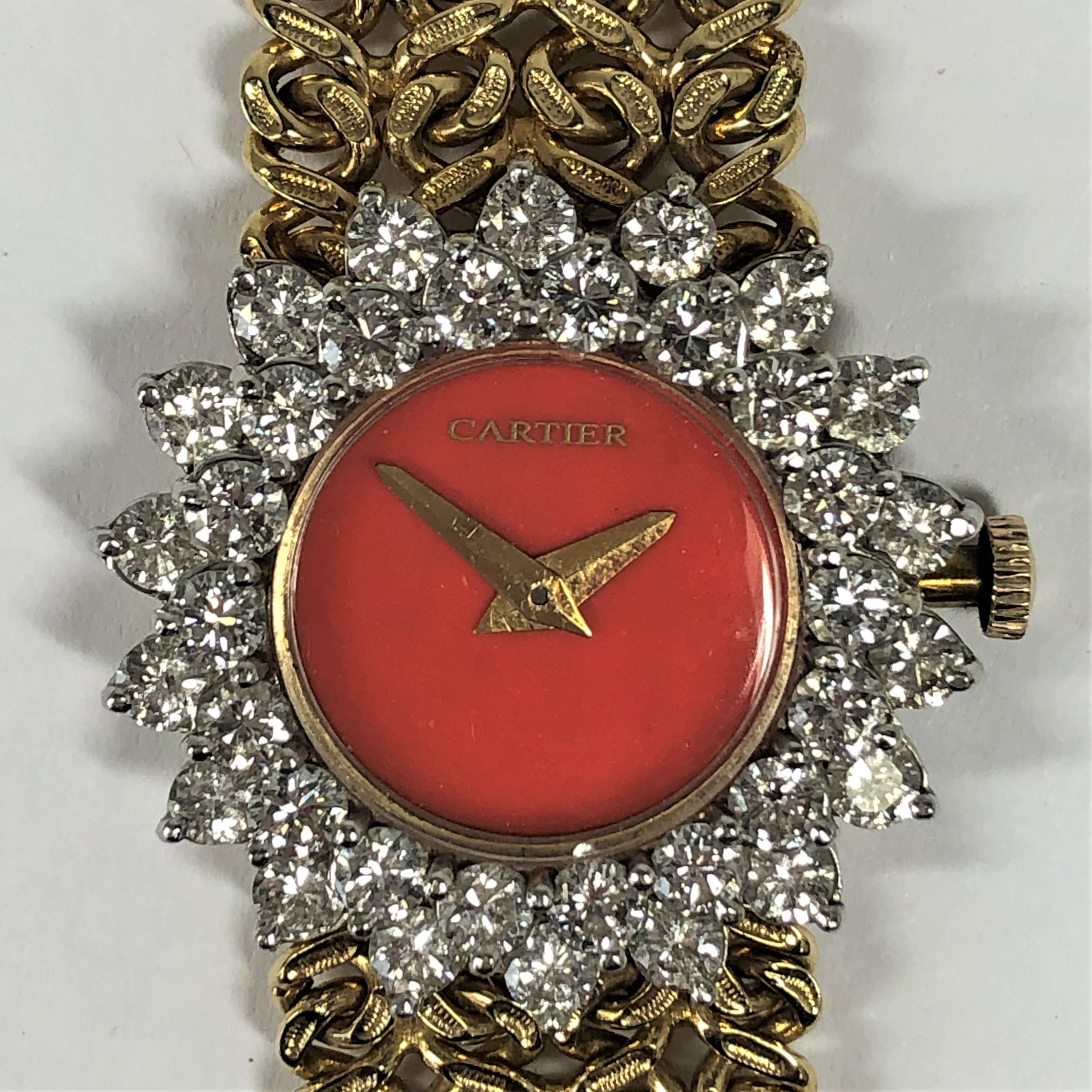 Manufactured for Cartier by Hammerman Brothers in the 1970s. This lovely 14K Yellow Gold
watch has a richly colored coral dial surrounded by two rows of round brilliant cut diamonds, weighing an approximate total of 3.5Ct of overall G/H Color and