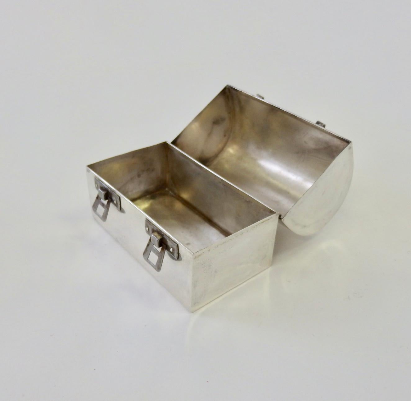 Cartier hand formed evening purse clutch in the shape of a diminutive lunch box. Formed in sterling with steel latches.