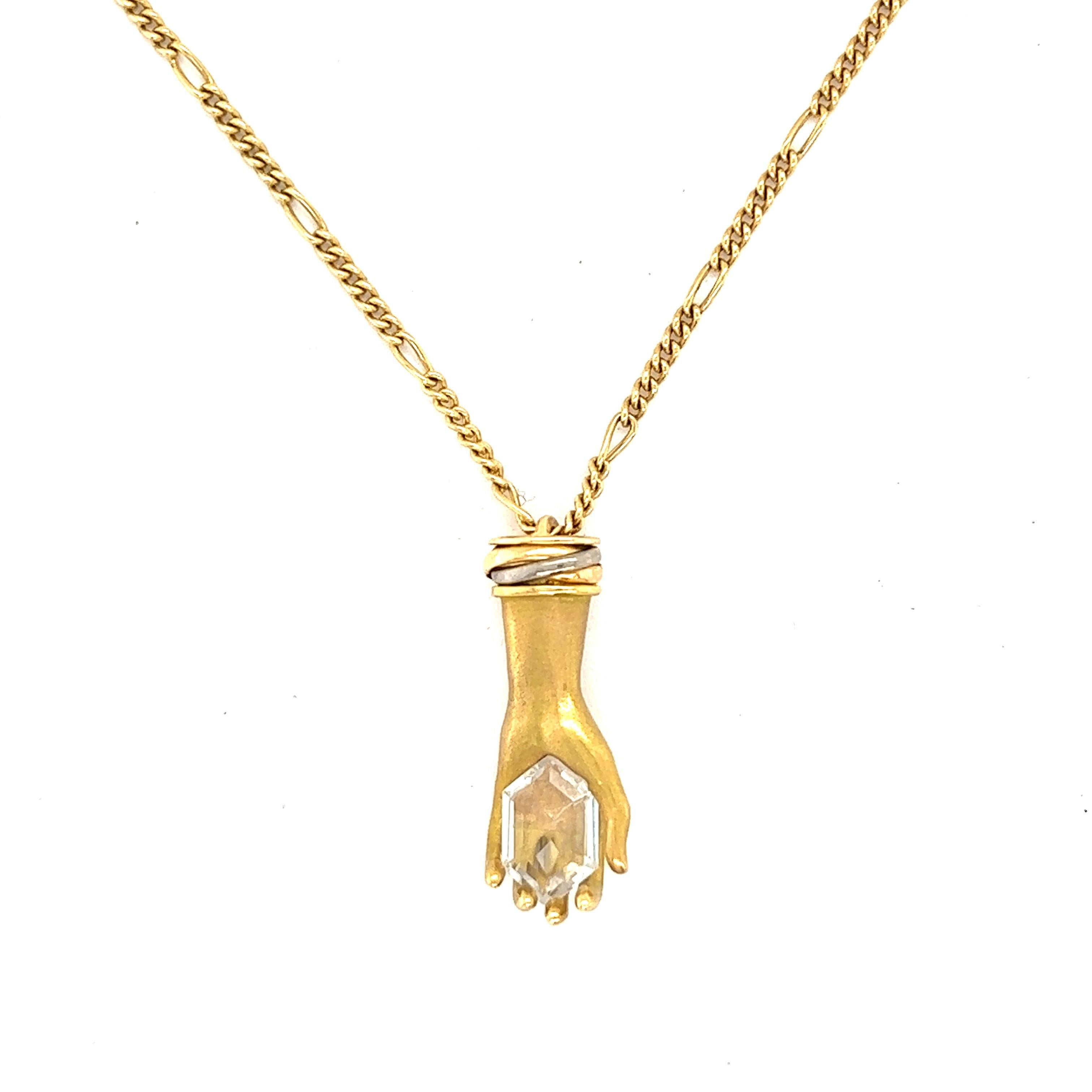 Cartier Hand Pendant Gold Necklace, numbered

A left hand clutching on to a white gemstone; 18 karat yellow gold; marked Cartier, 750, 144692

Size: Pendant width 0.9 cm, length 2.2 cm; chain length 15 inches
Total weight: 8.5 grams