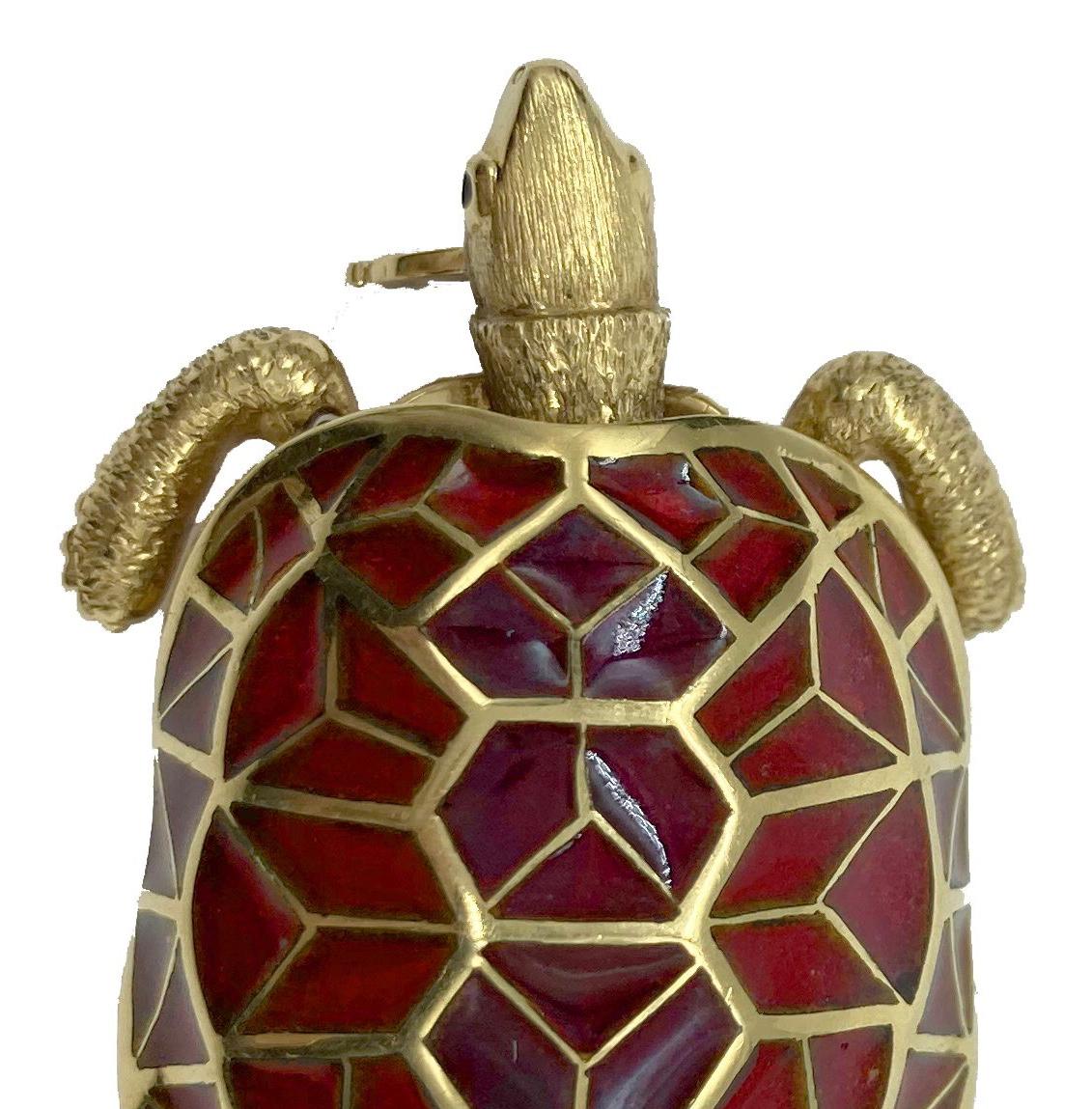 A collectible Cartier turtle brooch in 18 karat gold and hardstone.