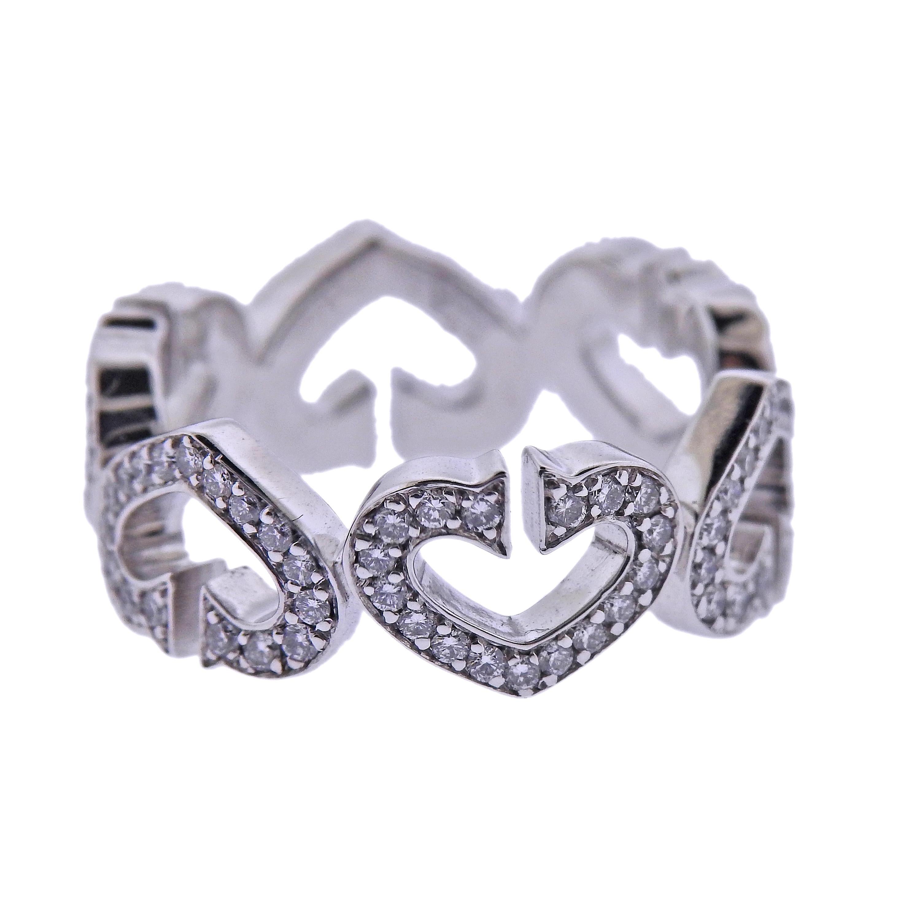 18k white gold heart band ring by Cartier, with approx. 0.60ctw in diamonds. Comes in Cartier box. Size 5, width 7mm. Marked: AR3891, 49, 750, Cartier. Weight - 6 grams. 