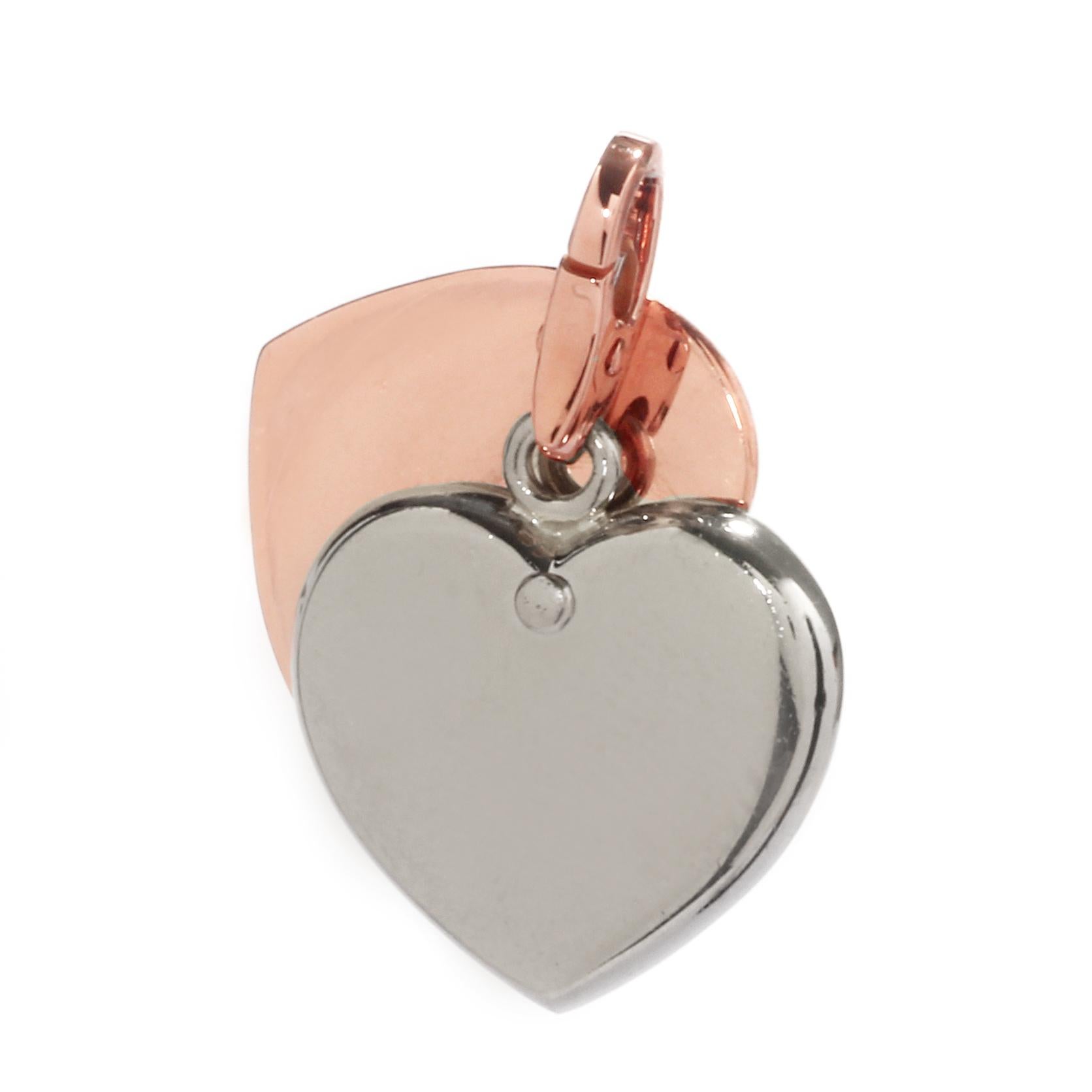 A lovely heart charm pendant by Cartier featuring 18k white and rose gold, forming a perfect colorful combination.

Hallmarks: Cartier, 750, Unique Serial Number
Weight: 14.4 Grams
Dimensions: .74″ Inches wide by 1.14″ Inches in